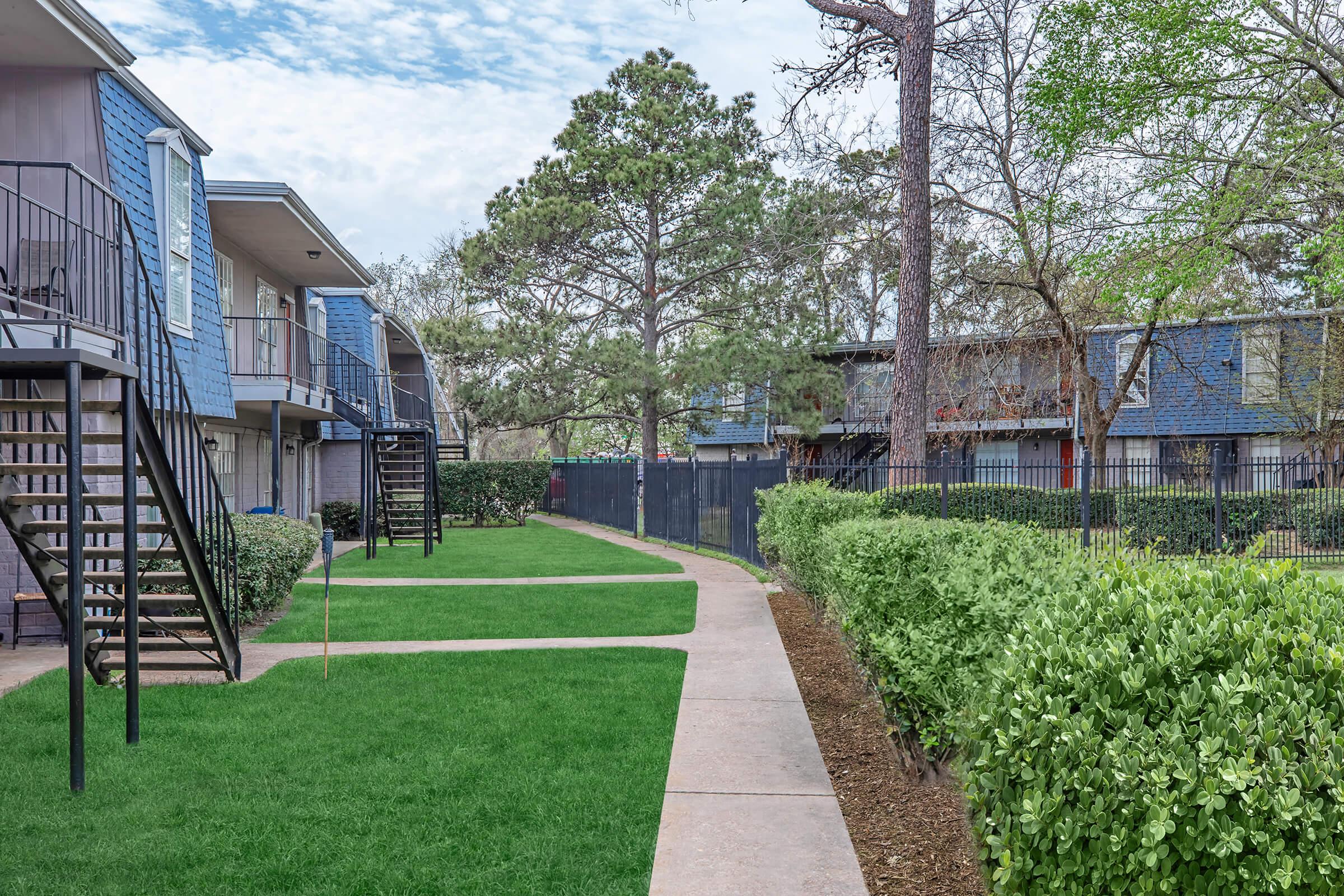 a house with a lawn in front of a building