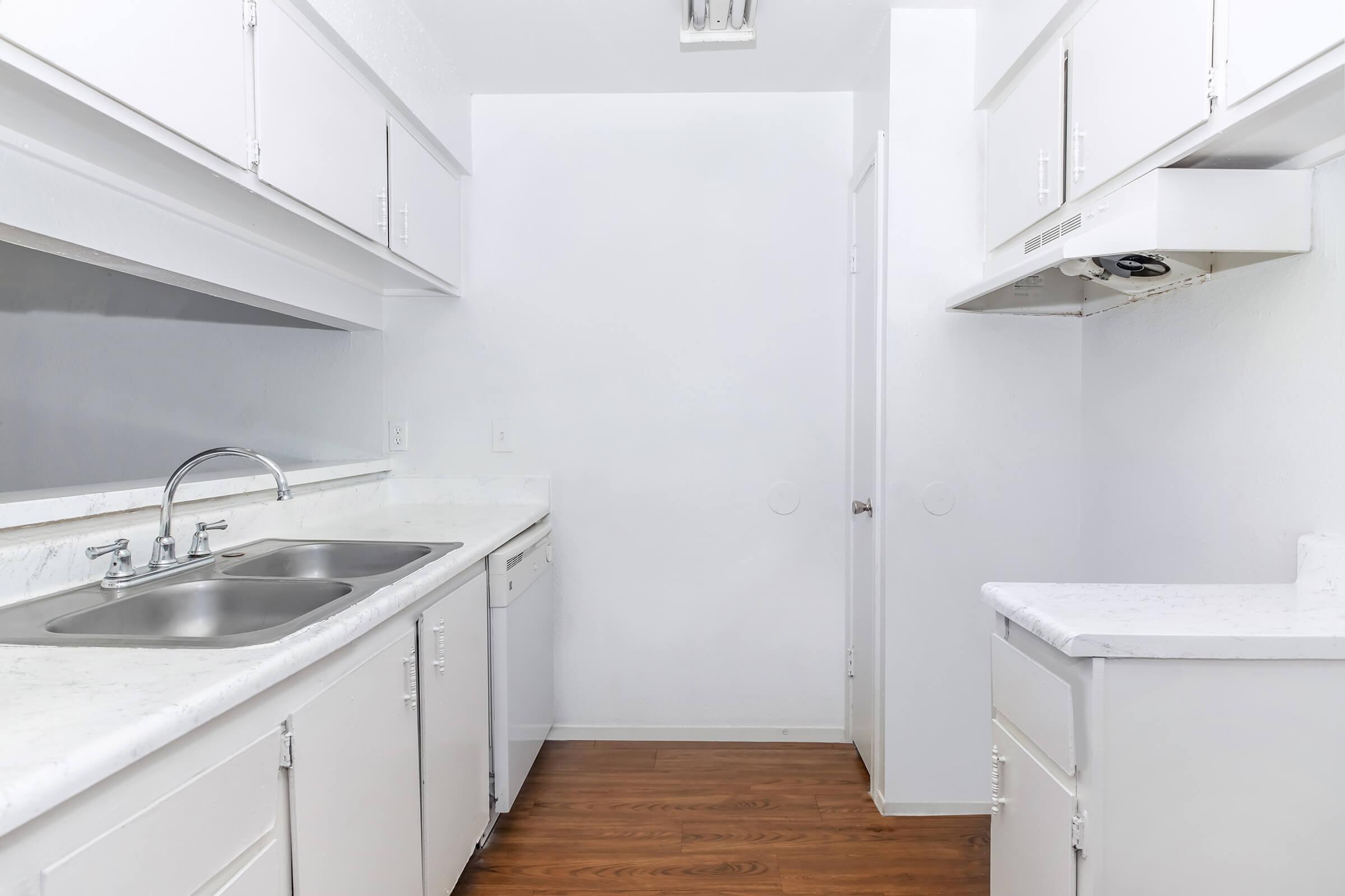 a kitchen with a sink and a mirror