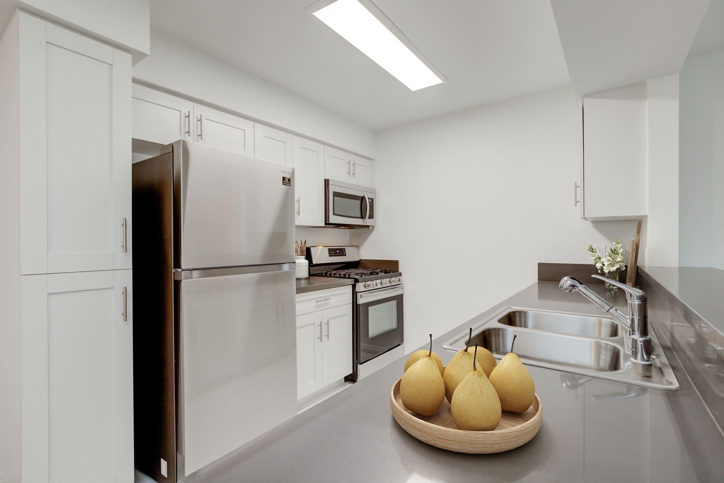 a kitchen with a sink and a refrigerator