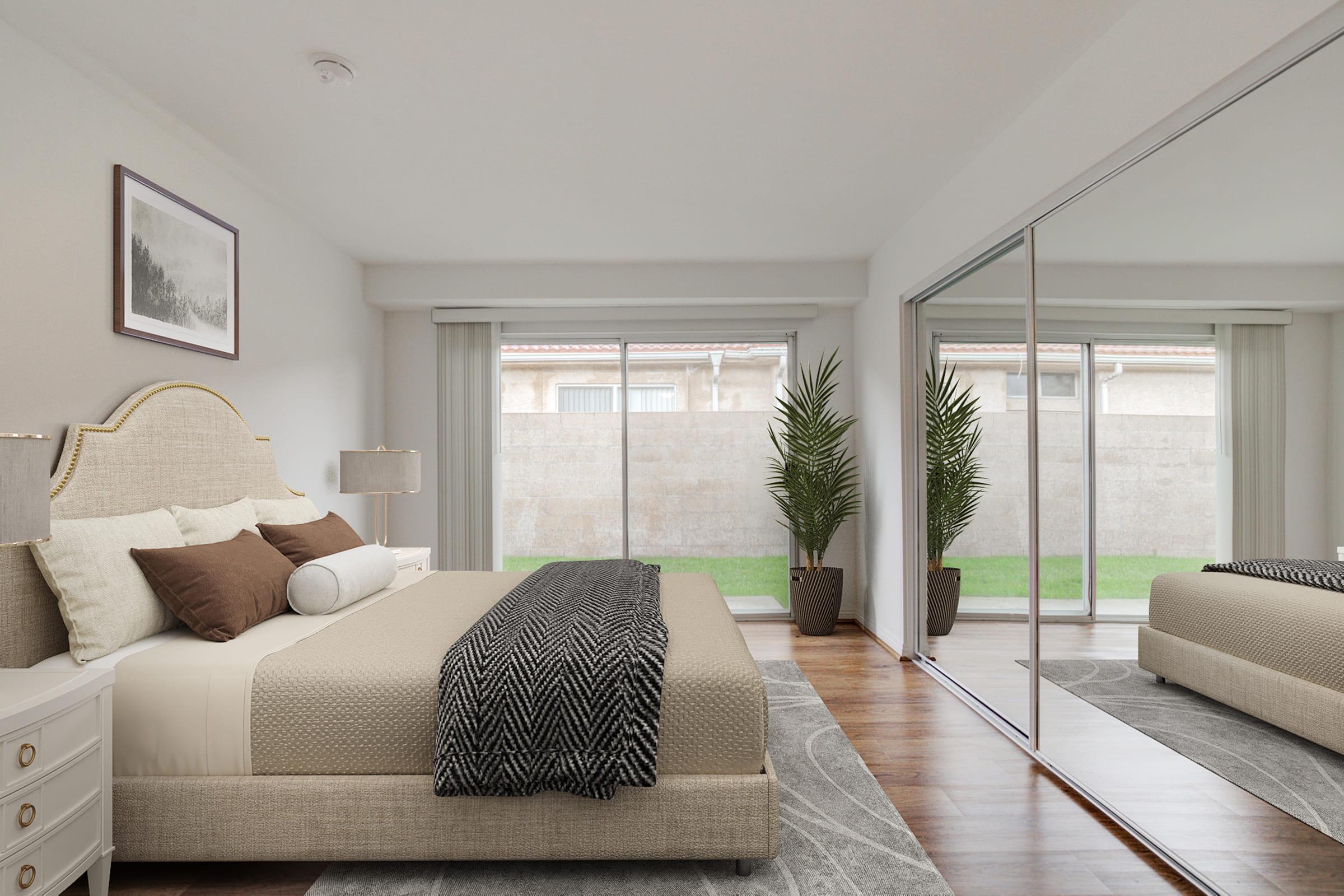 a living room with a bed and a large window