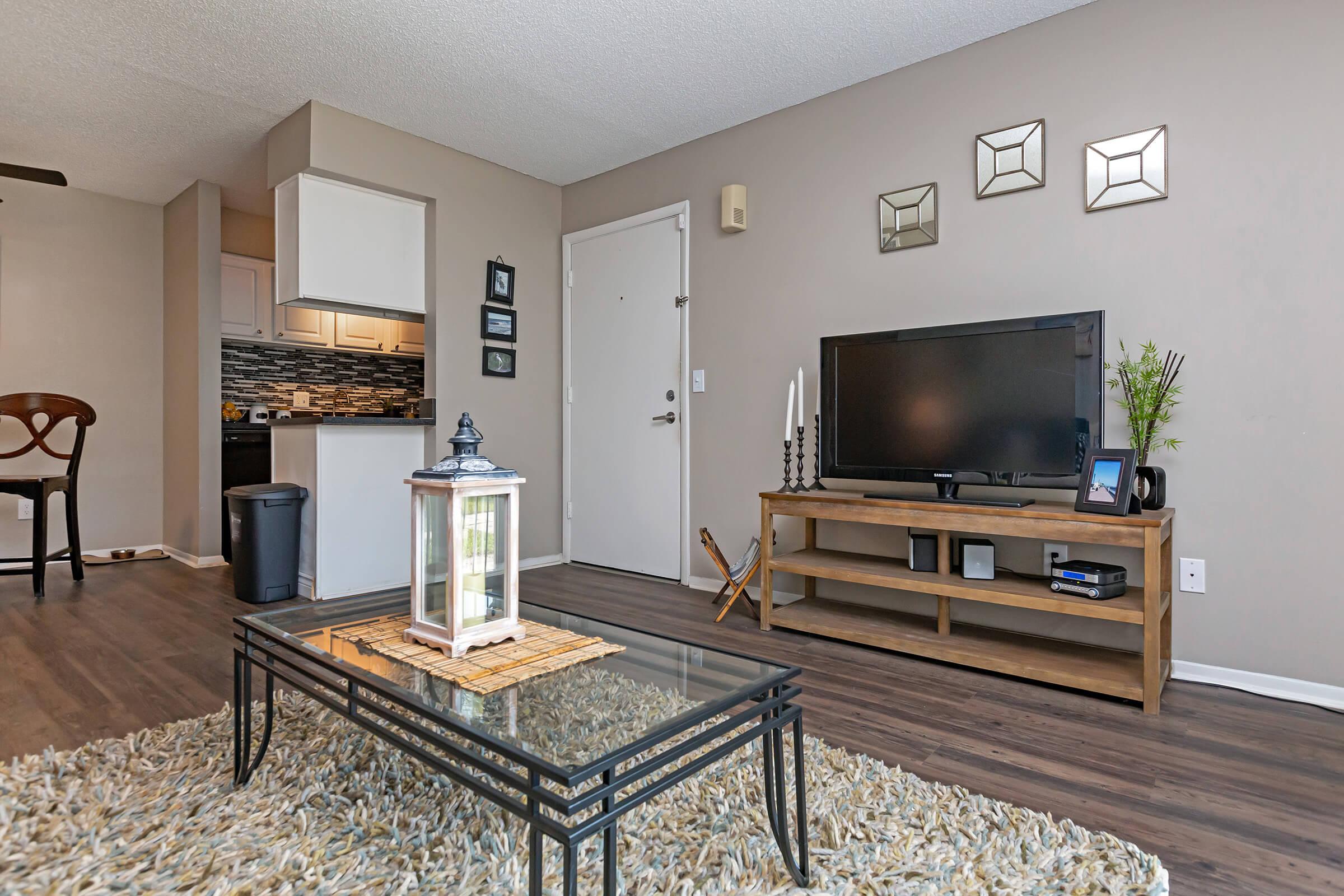 a living room filled with furniture and a flat screen tv