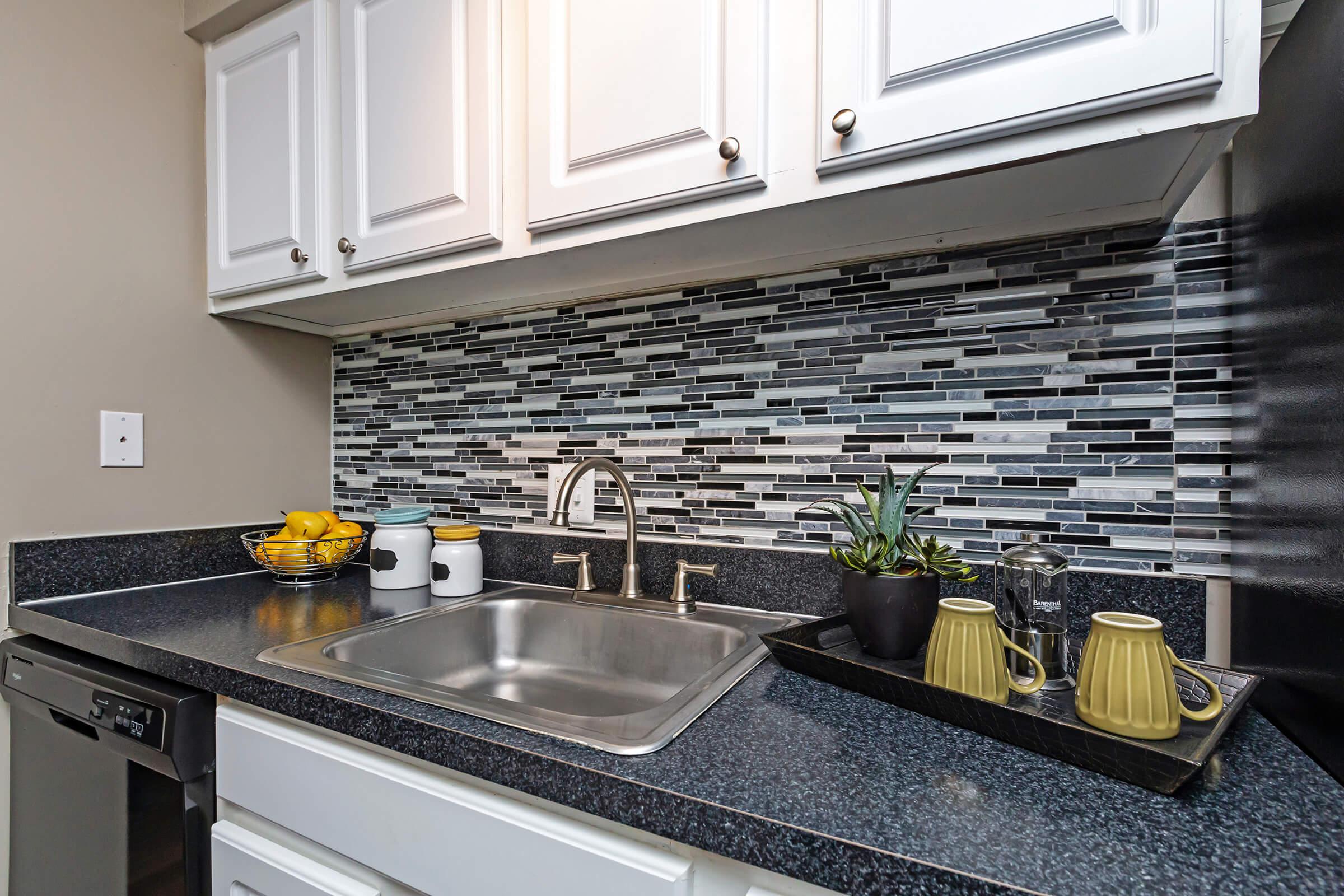 a stove top oven sitting inside of a kitchen
