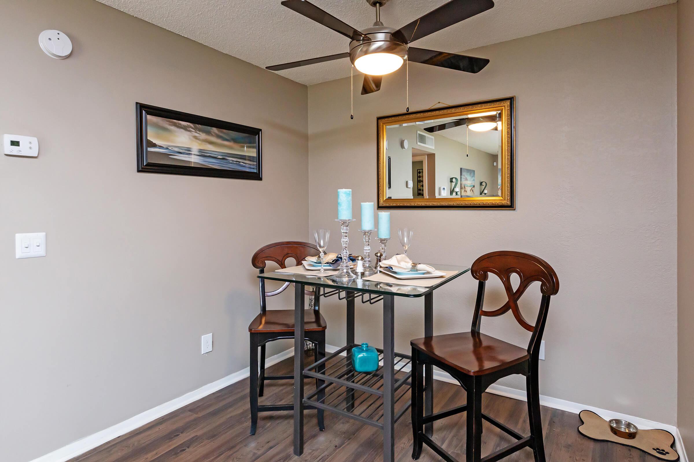 a room with a couch a table and chairs
