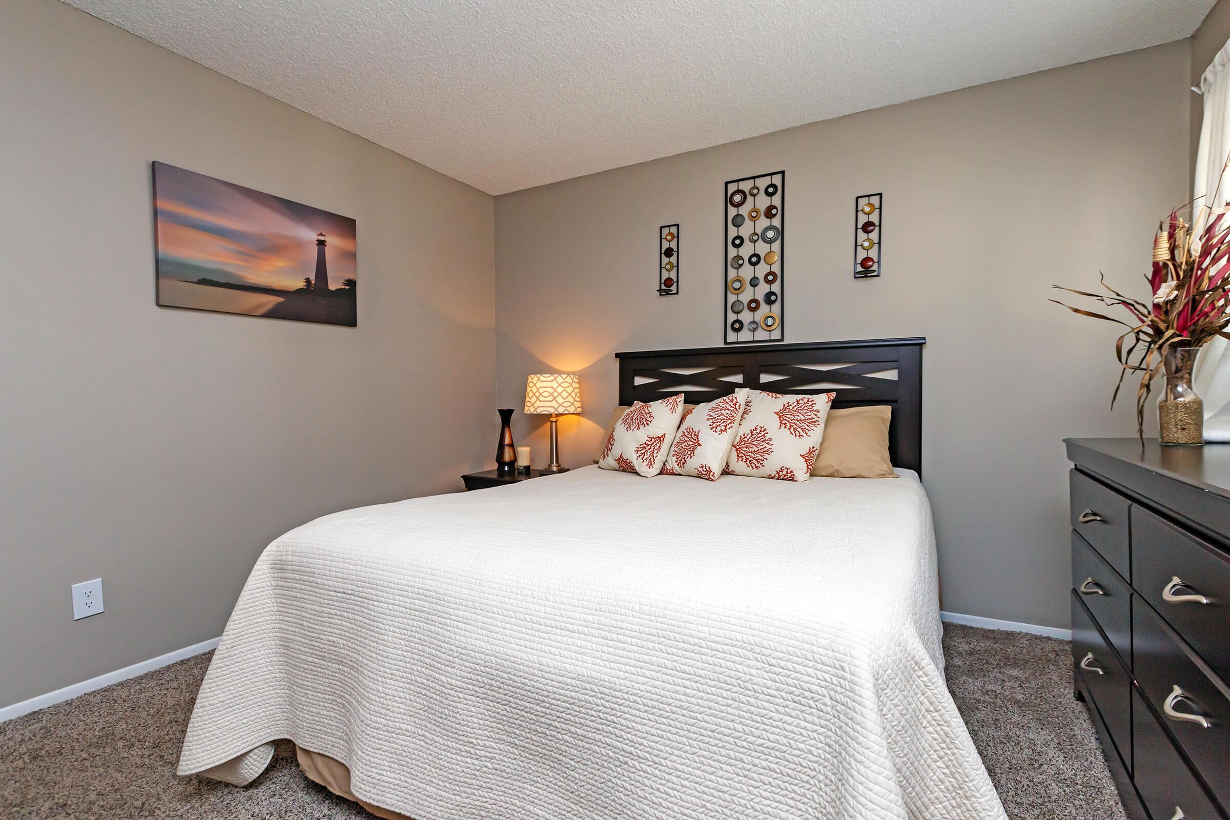 a bedroom with a bed in a room