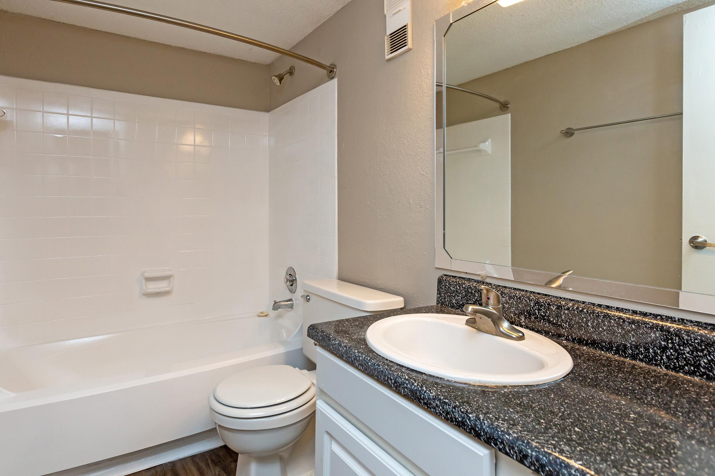 a white tub sitting next to a sink