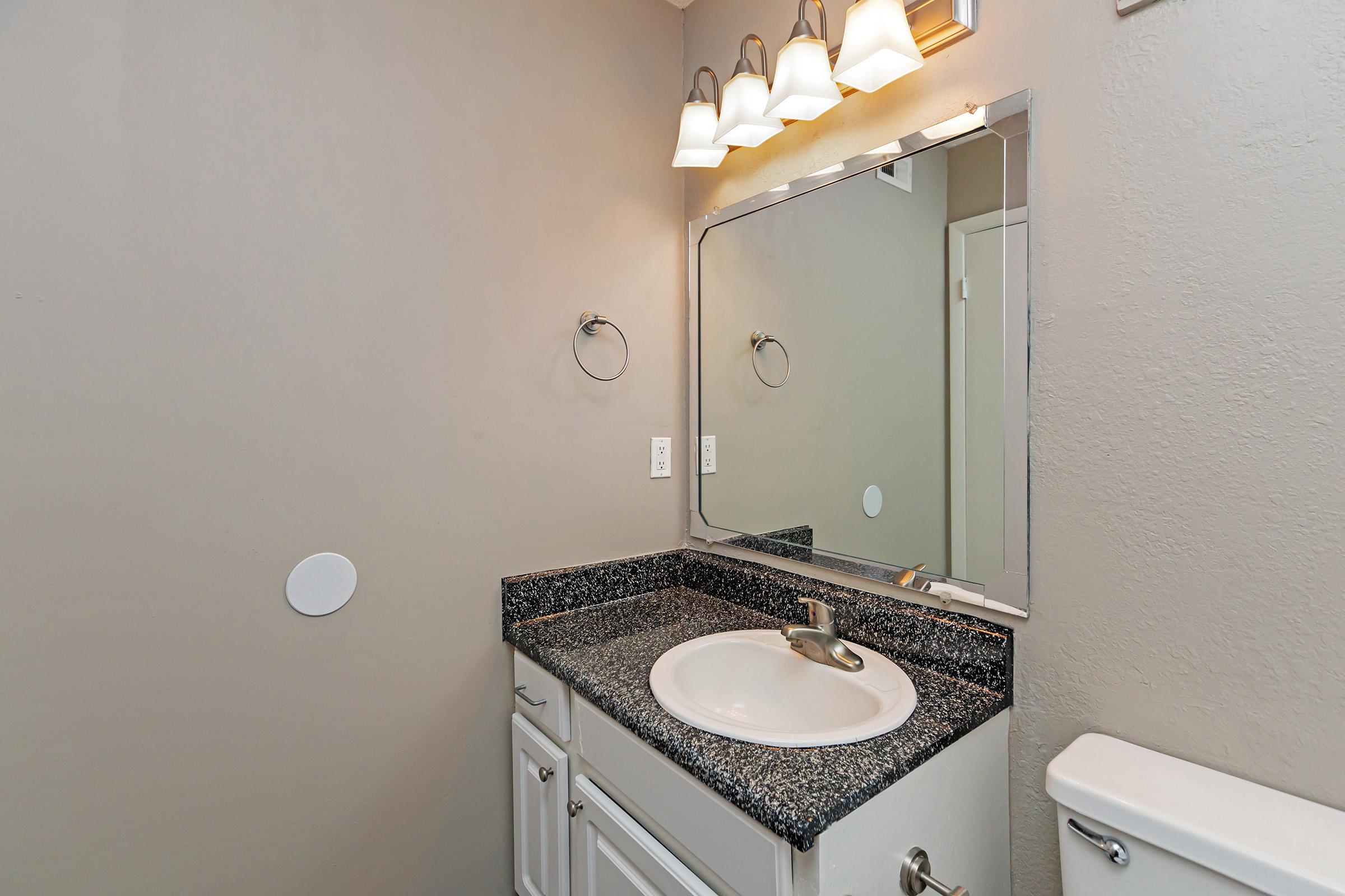 a white sink and a mirror
