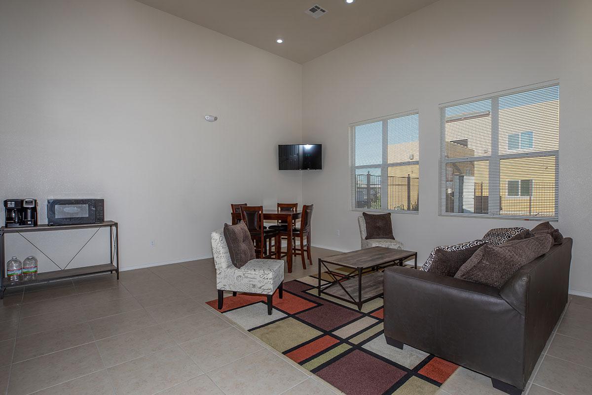 a living room filled with furniture and a large window