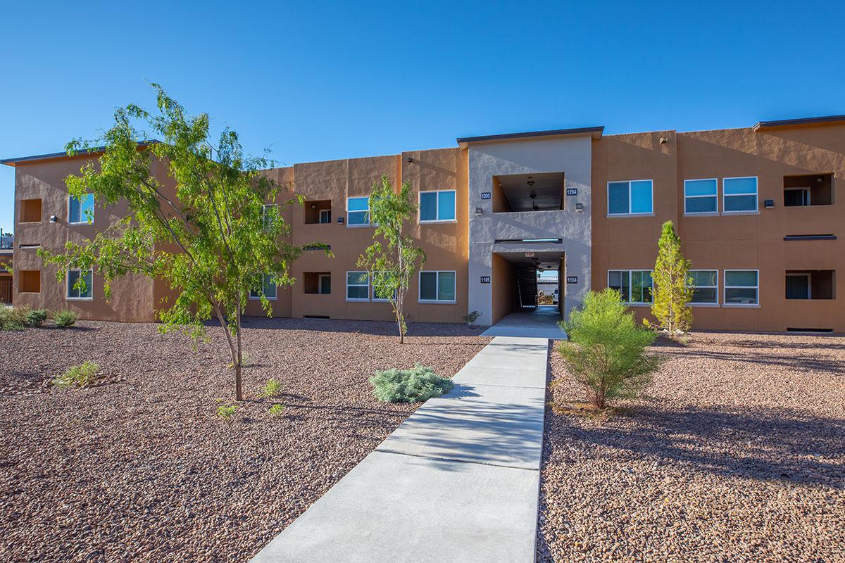 a dirt road in front of a building