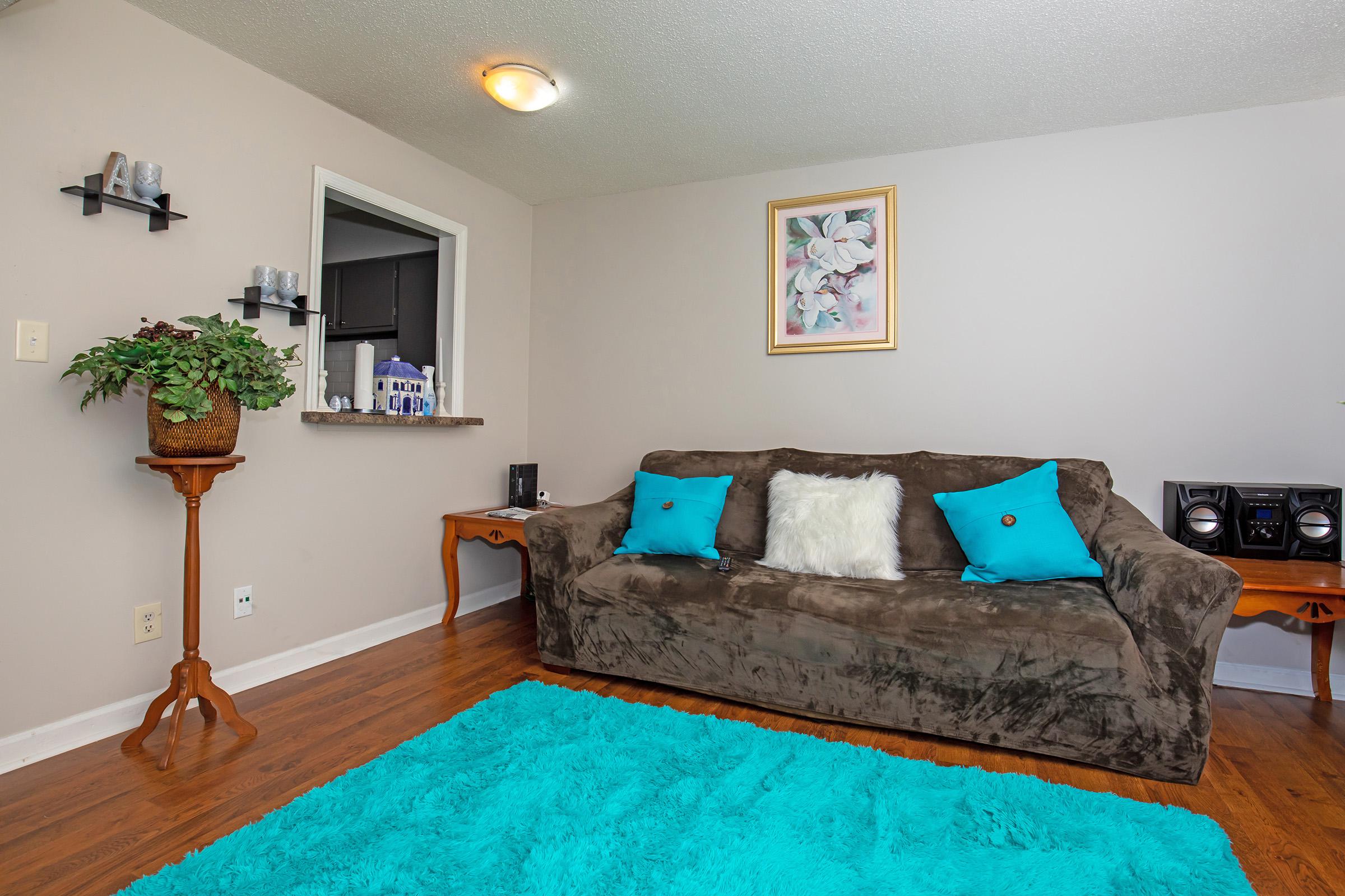 a living room filled with furniture and a flat screen tv