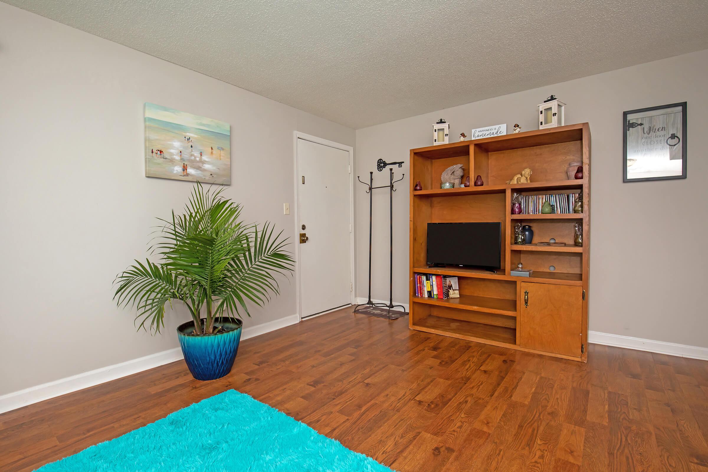 a living room filled with furniture and a flat screen tv