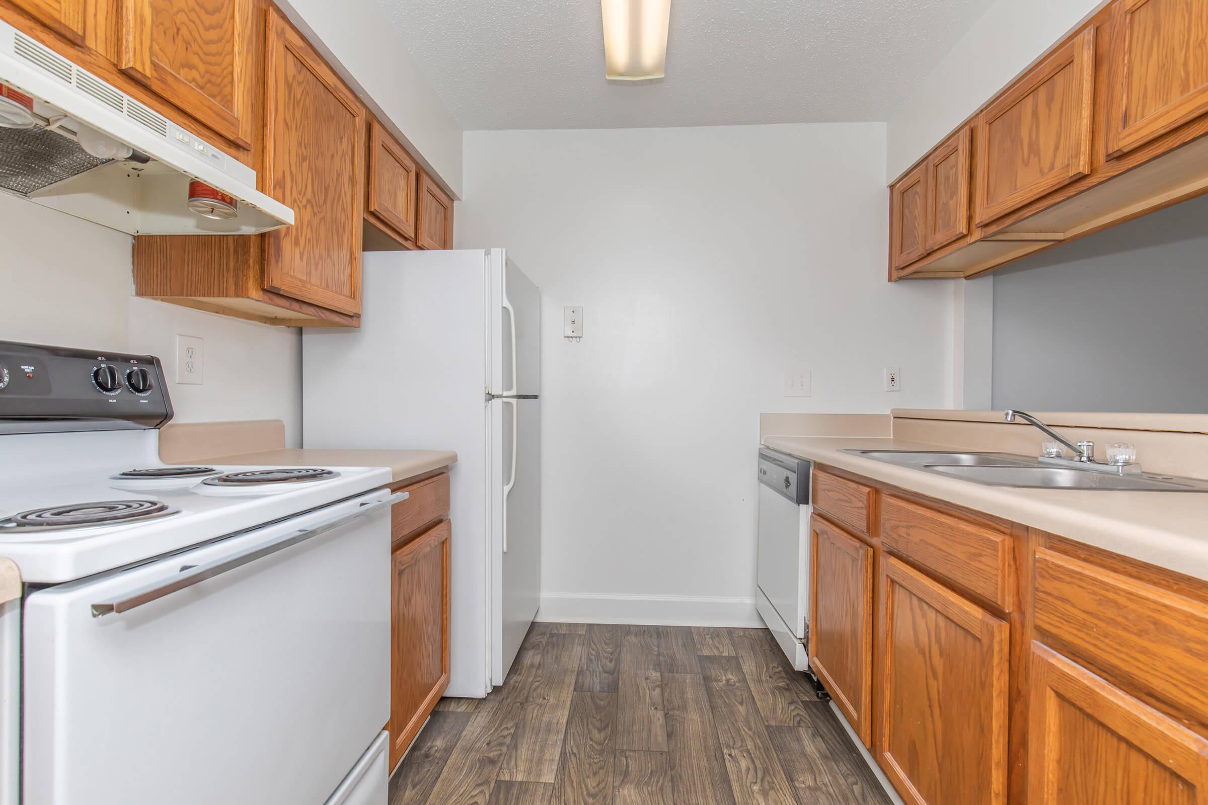 a kitchen with a stove sink and refrigerator