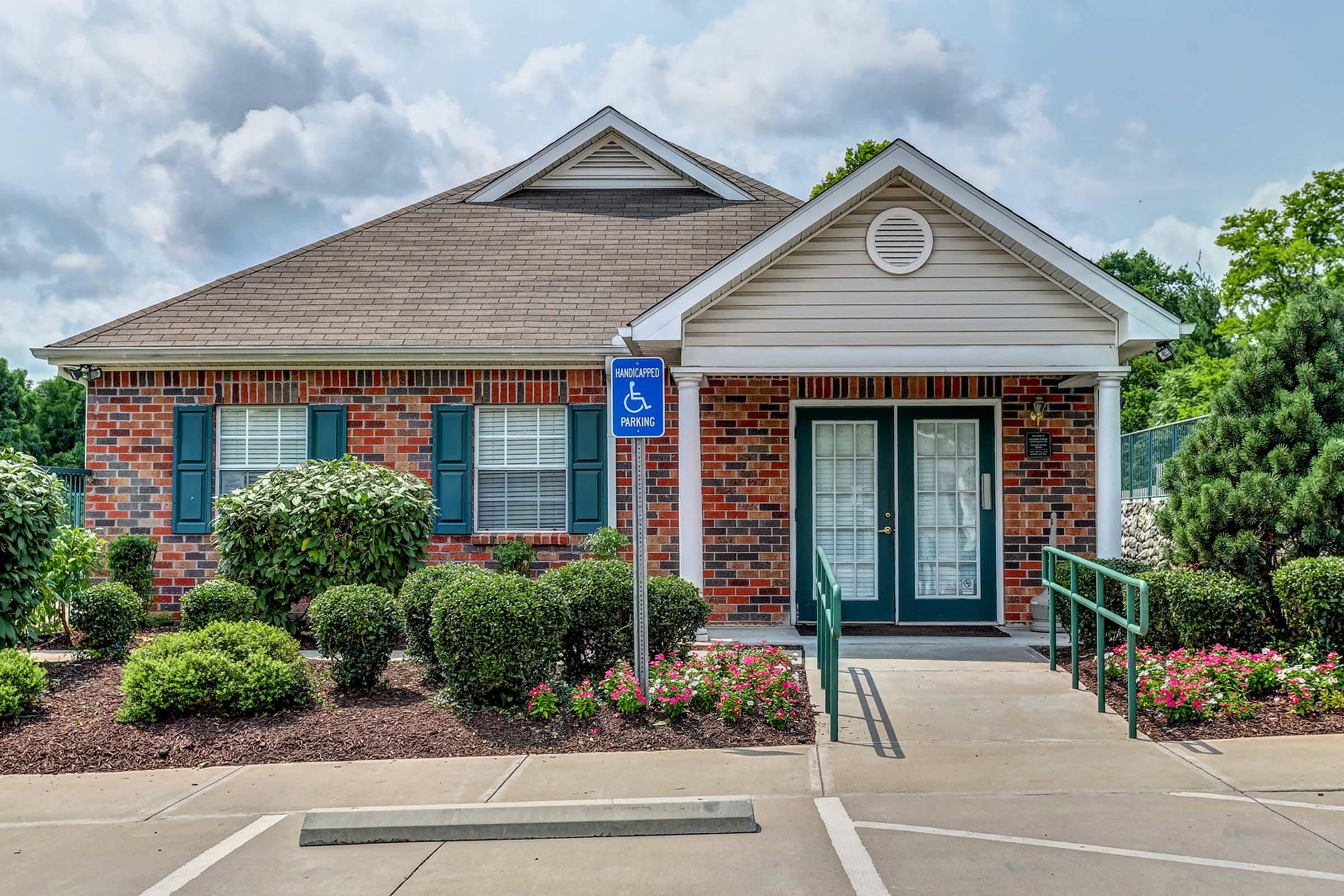 a house with bushes in front of a building