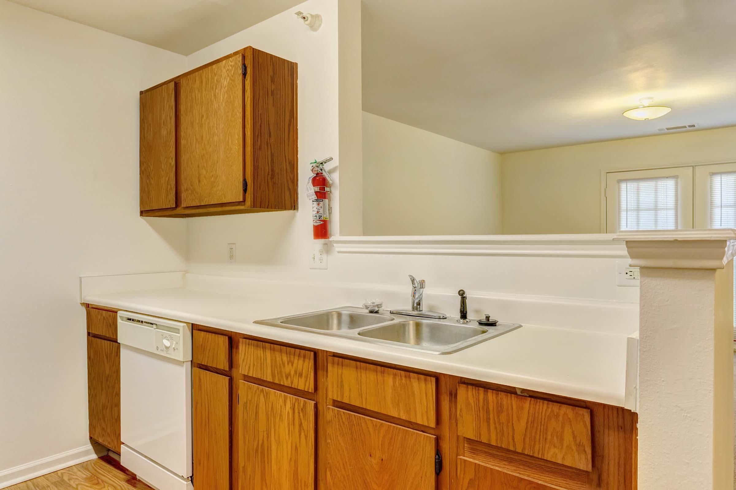 a kitchen with a sink and a mirror