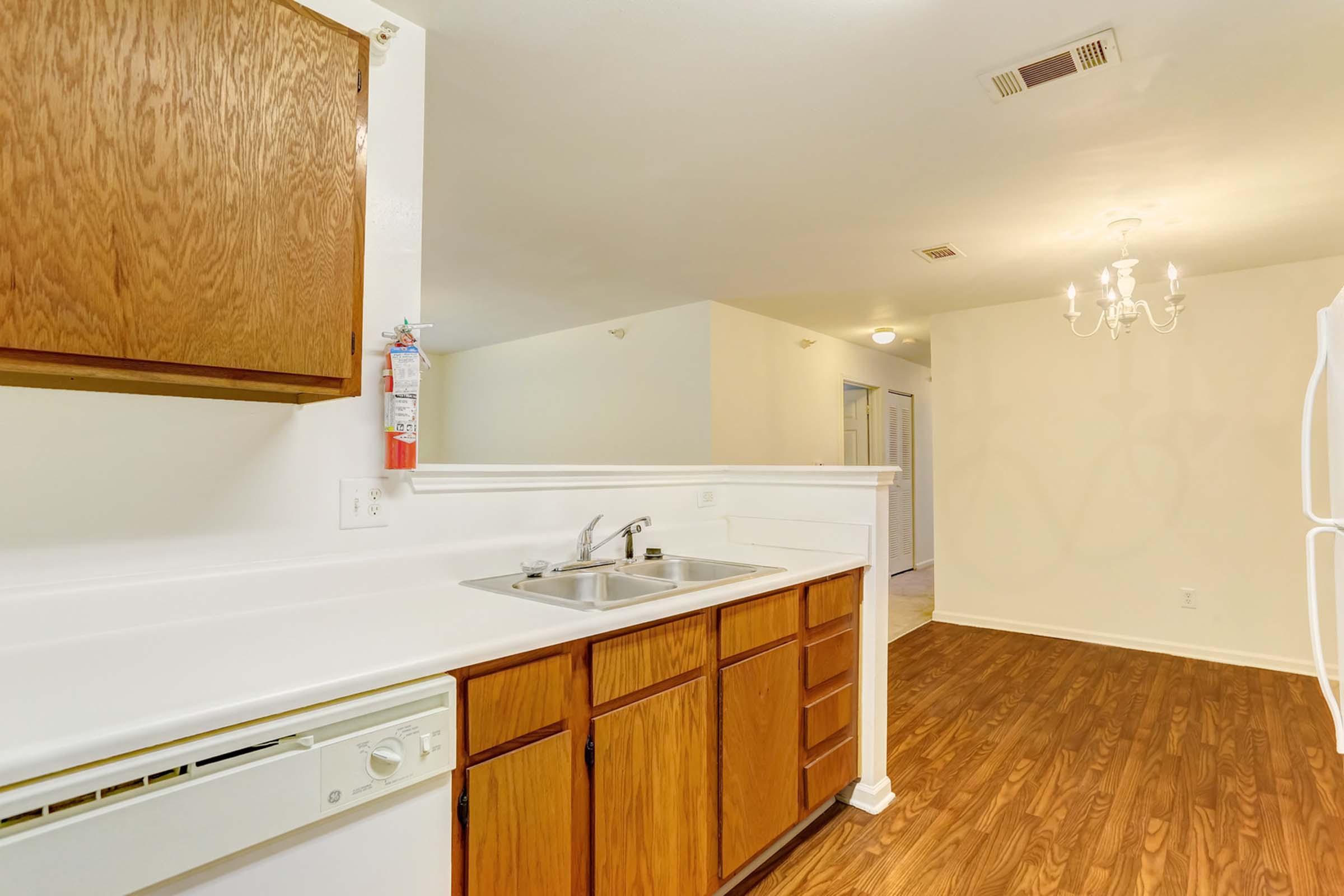 a kitchen with a sink and a mirror