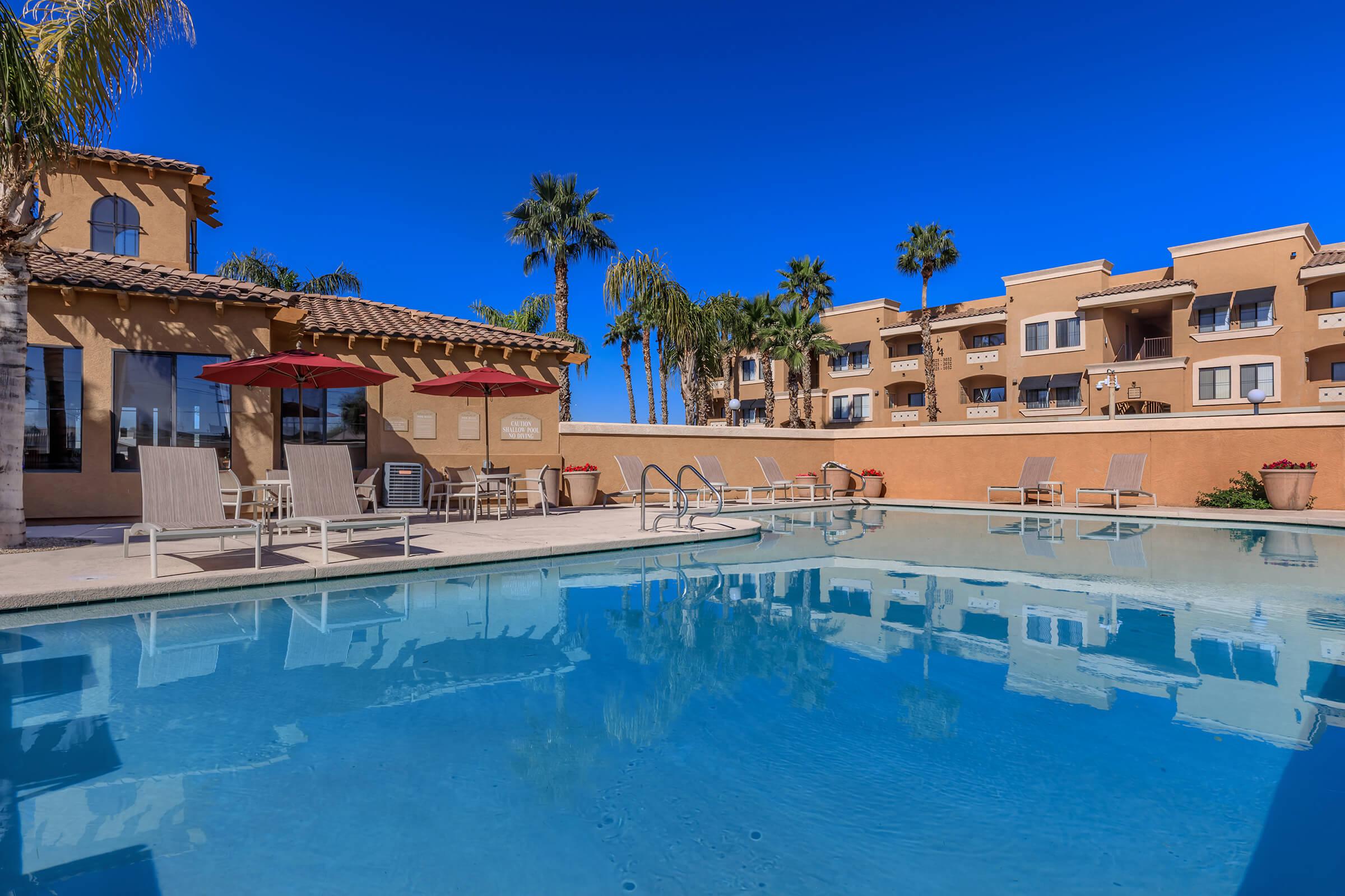 a blue pool of water in front of a building