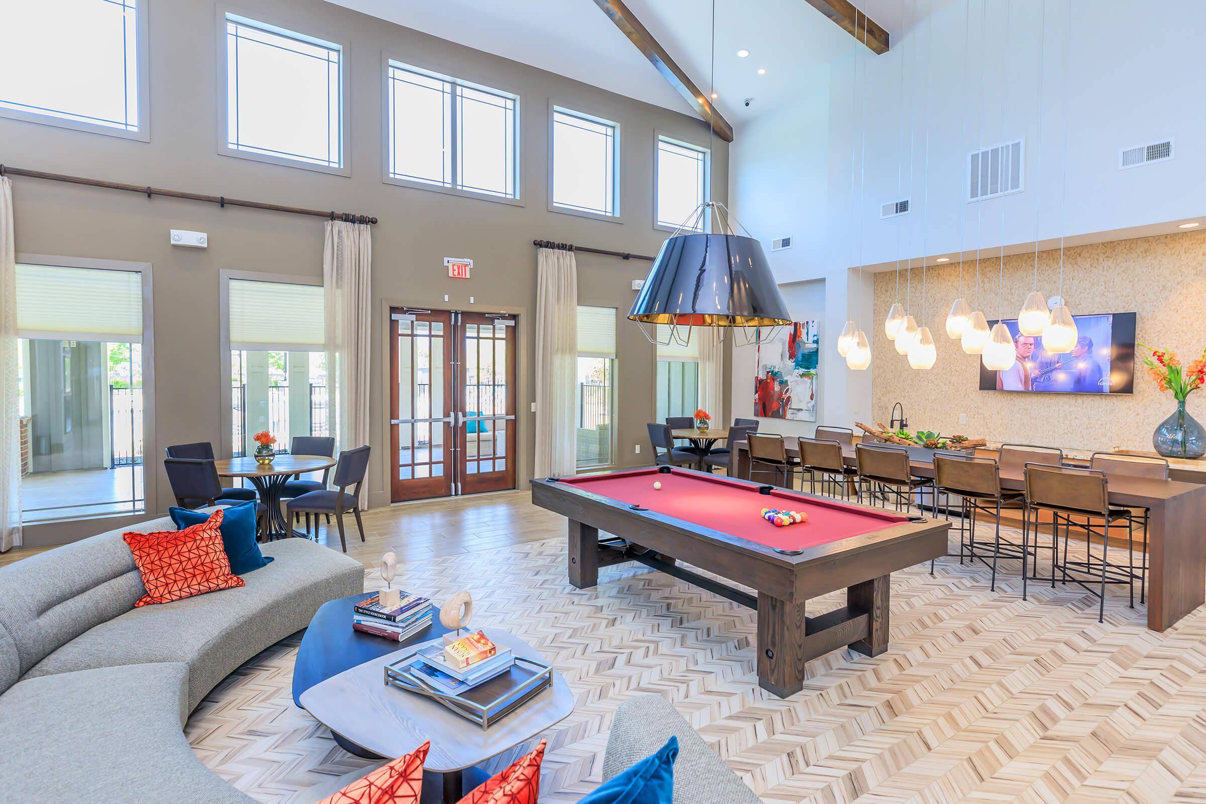 a living room filled with furniture and a large window