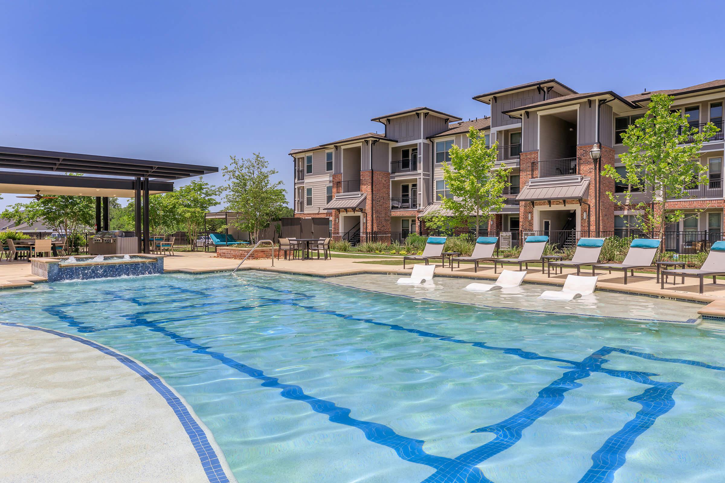 a house with a pool in front of a building