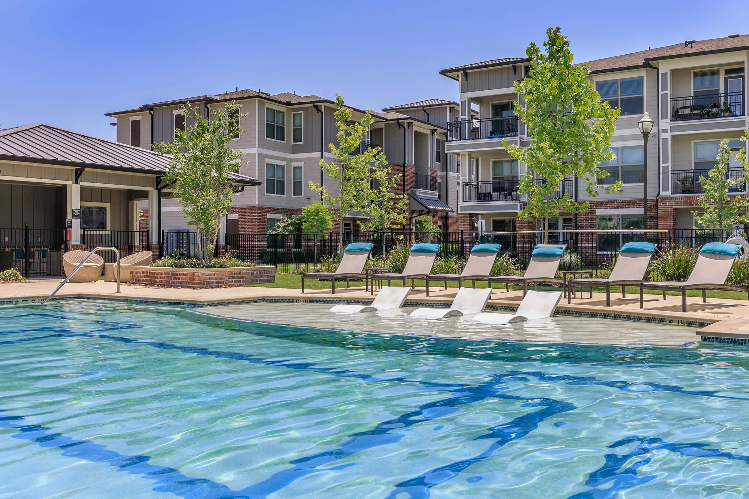 a large pool of water in front of a house