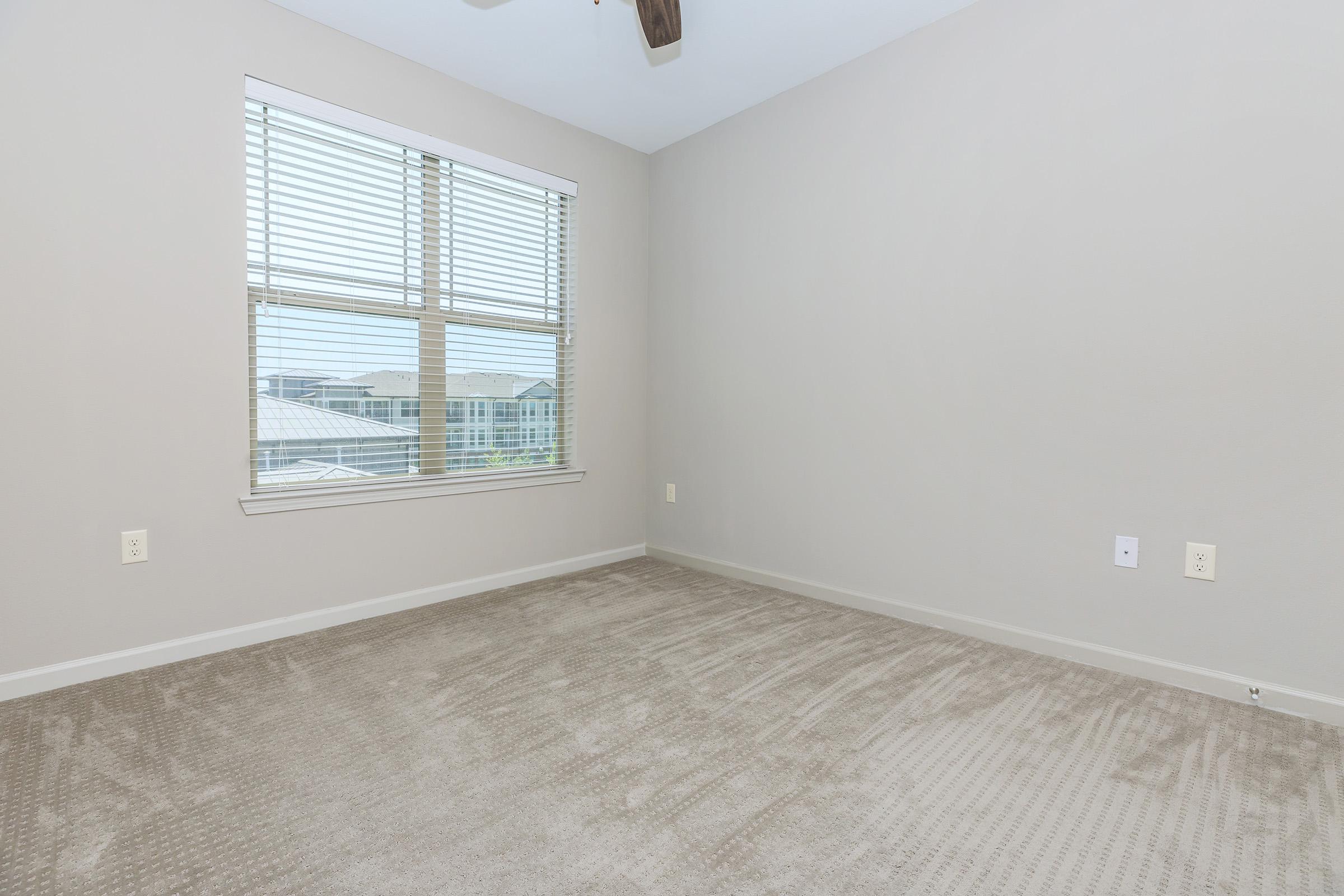 a bedroom with a large window