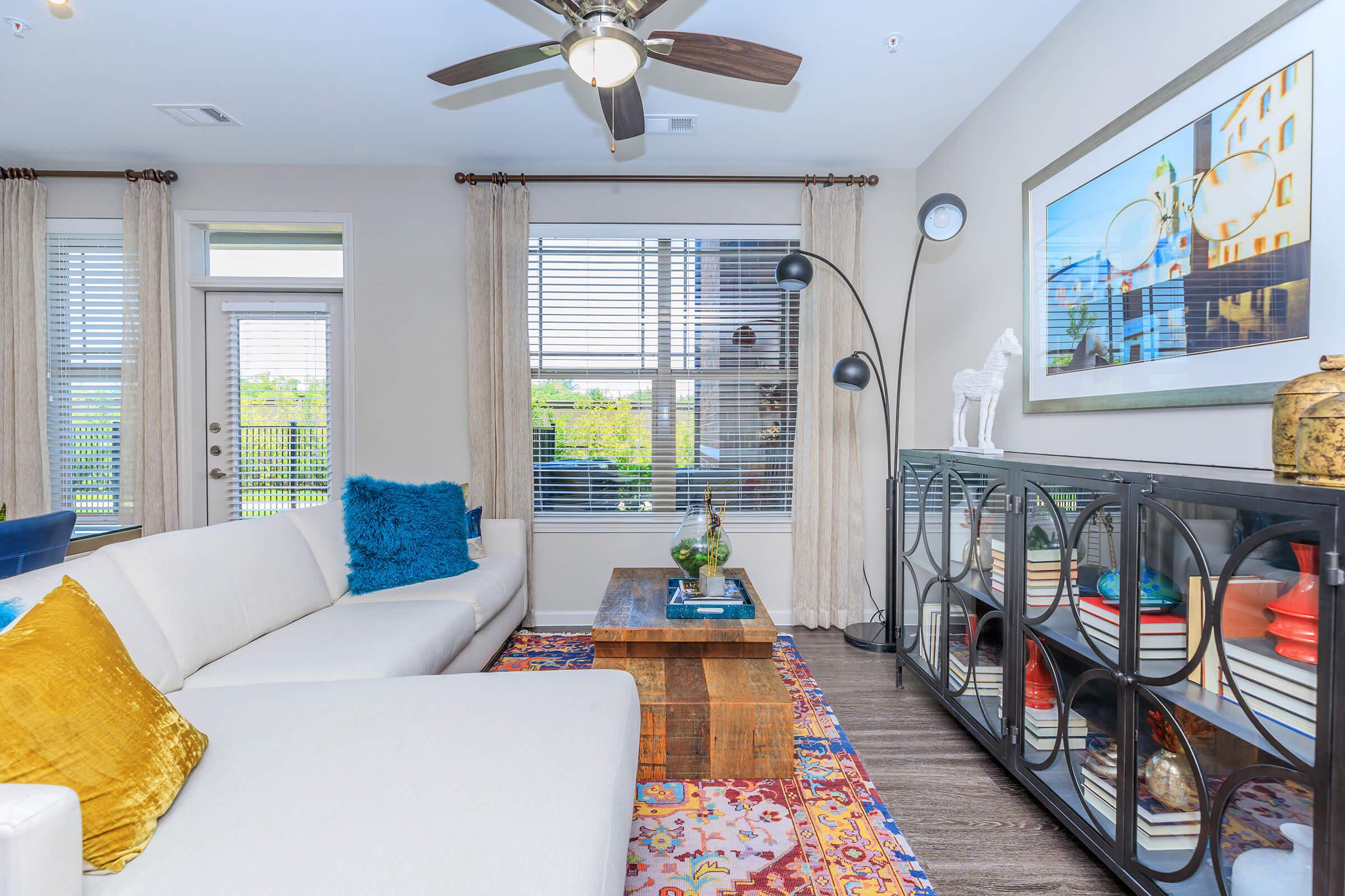 a living room filled with furniture and a large window