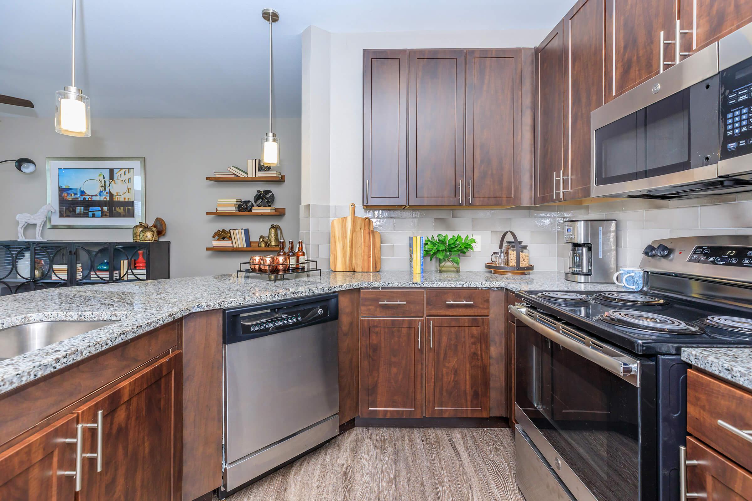 a kitchen with stainless steel appliances and wooden cabinets