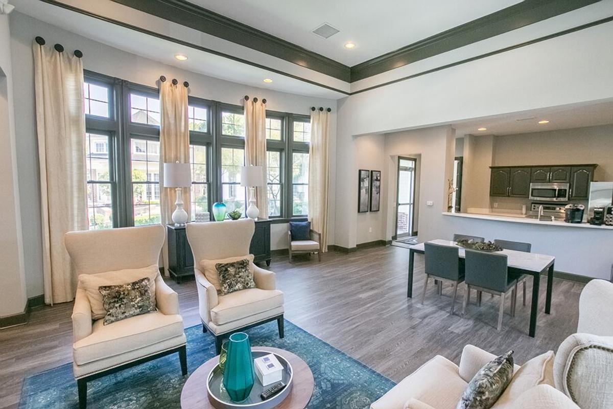 a living room filled with furniture and a large window