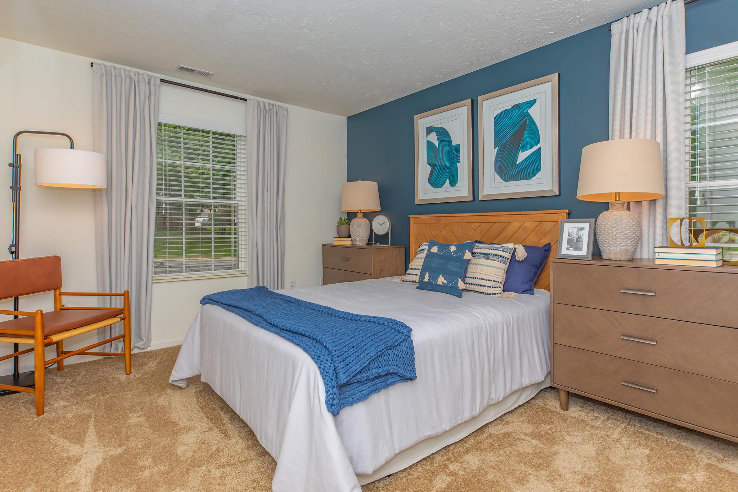 a bedroom with a bed and desk in a room