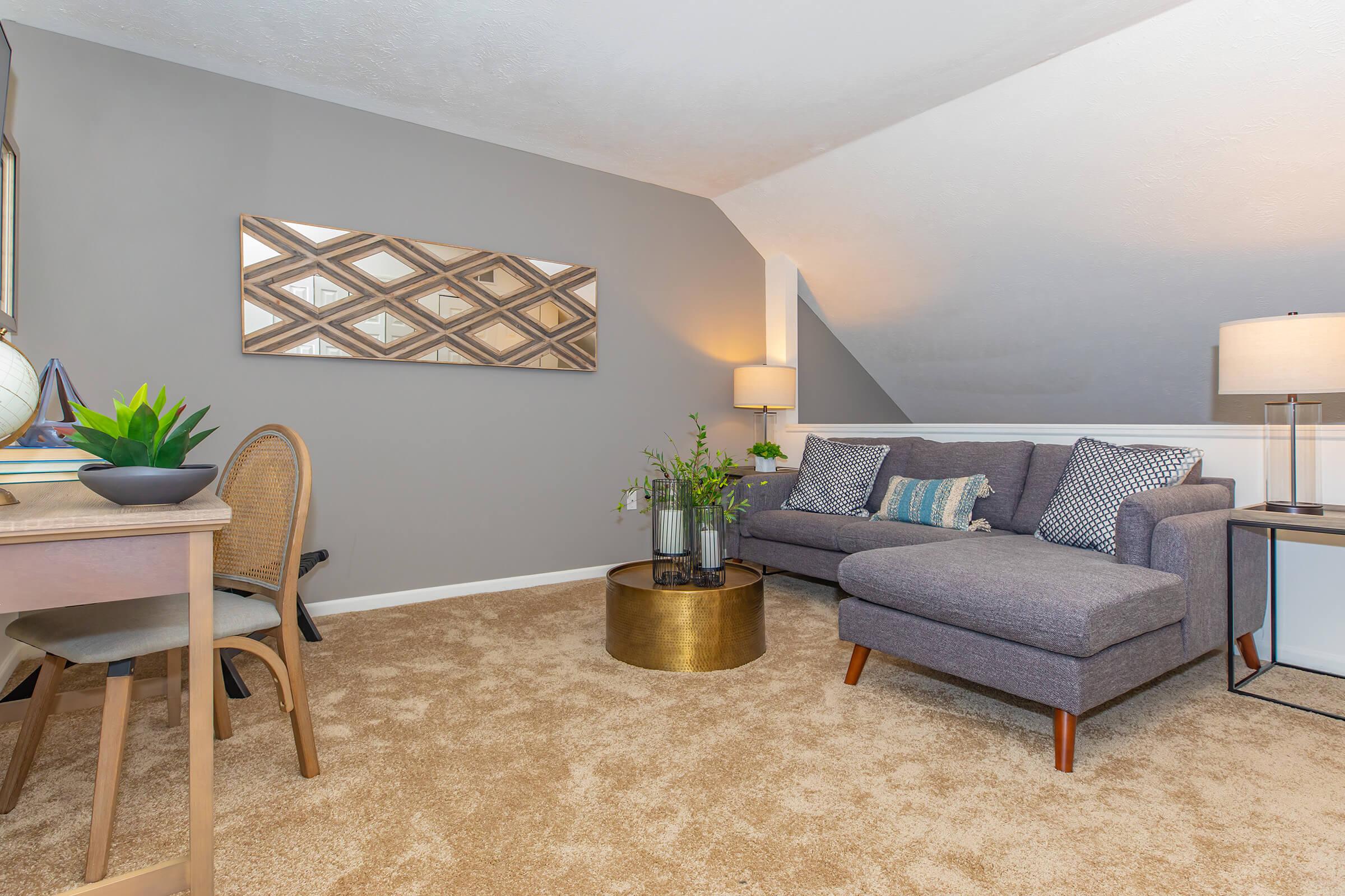 a living room filled with furniture and a lamp