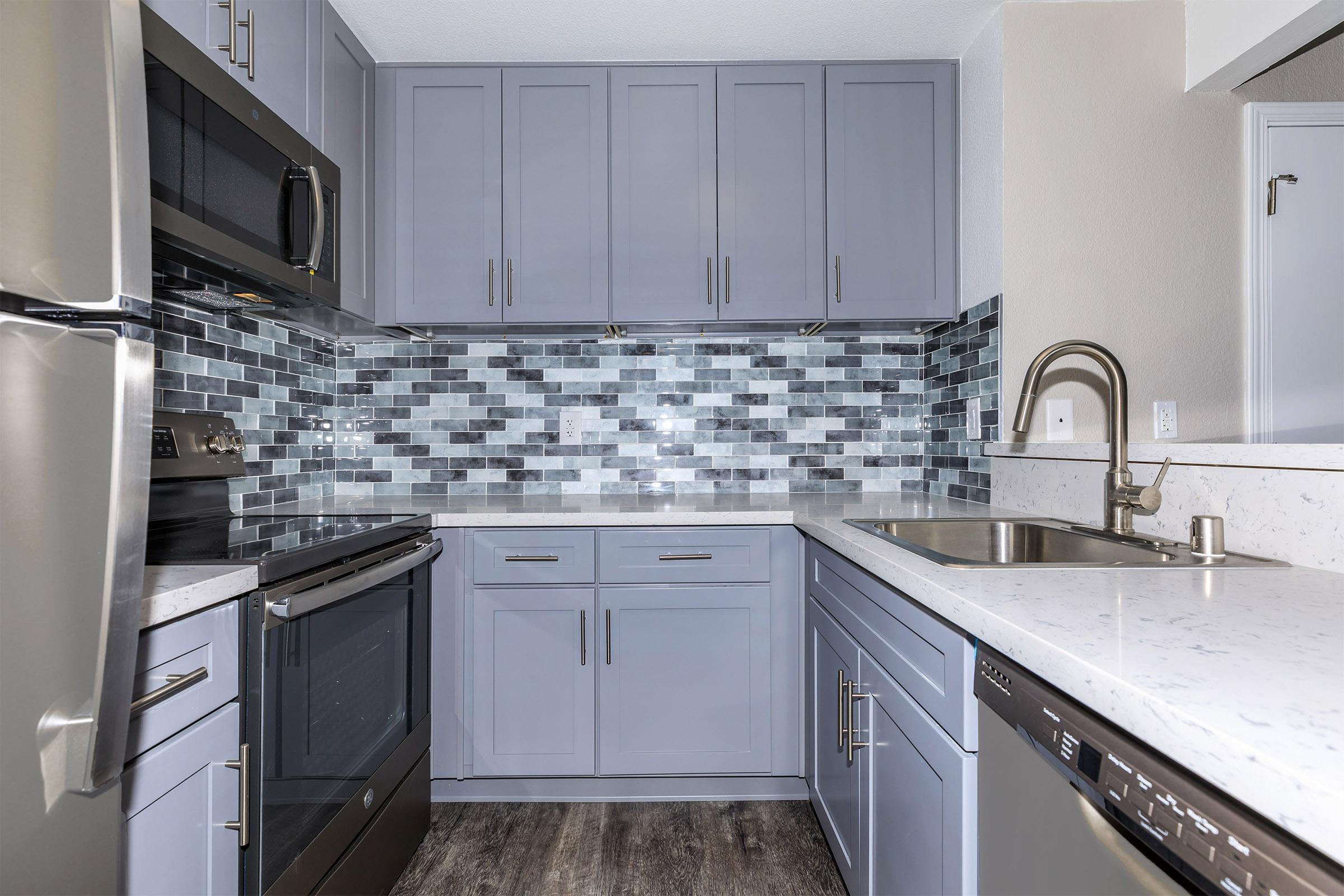 a kitchen with a stove sink and refrigerator