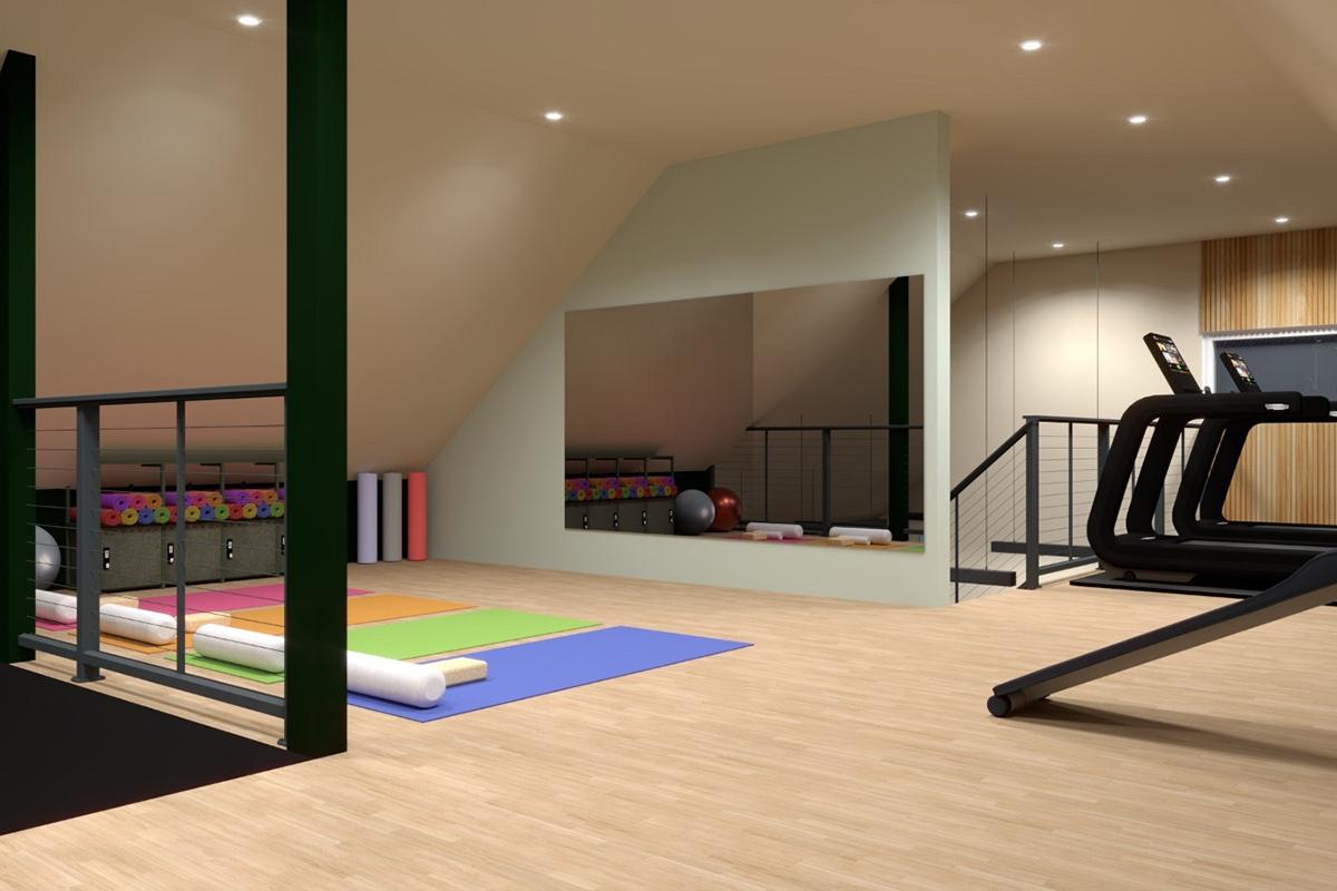A spacious, modern fitness area with colorful yoga mats and exercise equipment. Large mirrors reflect the gym space, while soft lighting enhances the atmosphere. The design features a wooden floor and various exercise tools, creating an inviting environment for workouts and stretching exercises.