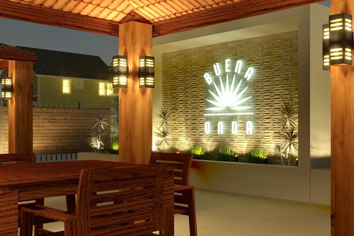 A modern outdoor seating area featuring wooden furniture under a pergola. The background has a lit wall with the text "BUENA ONDA" and a sun graphic, surrounded by greenery and soft lighting, creating a warm and inviting atmosphere during twilight.