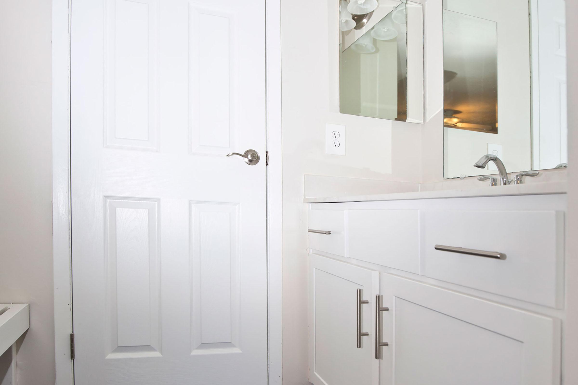 a room with a sink and a mirror