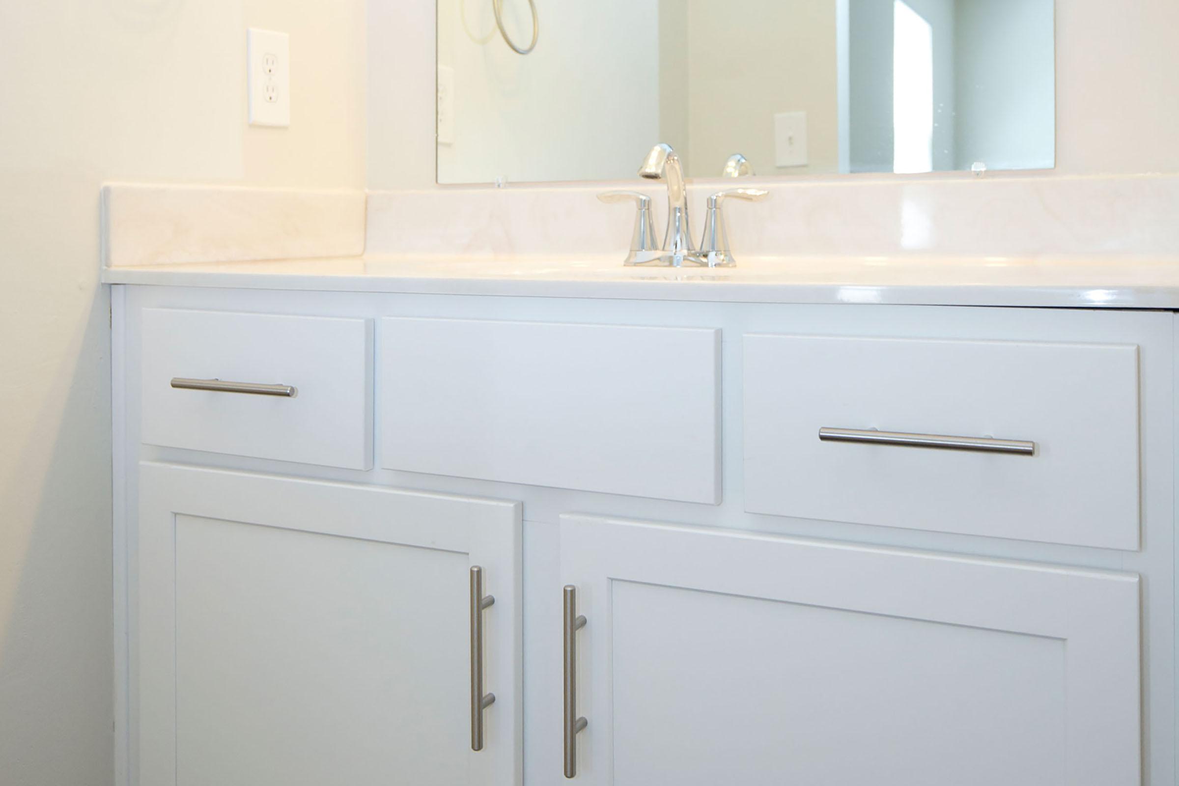 a kitchen with a sink and a mirror