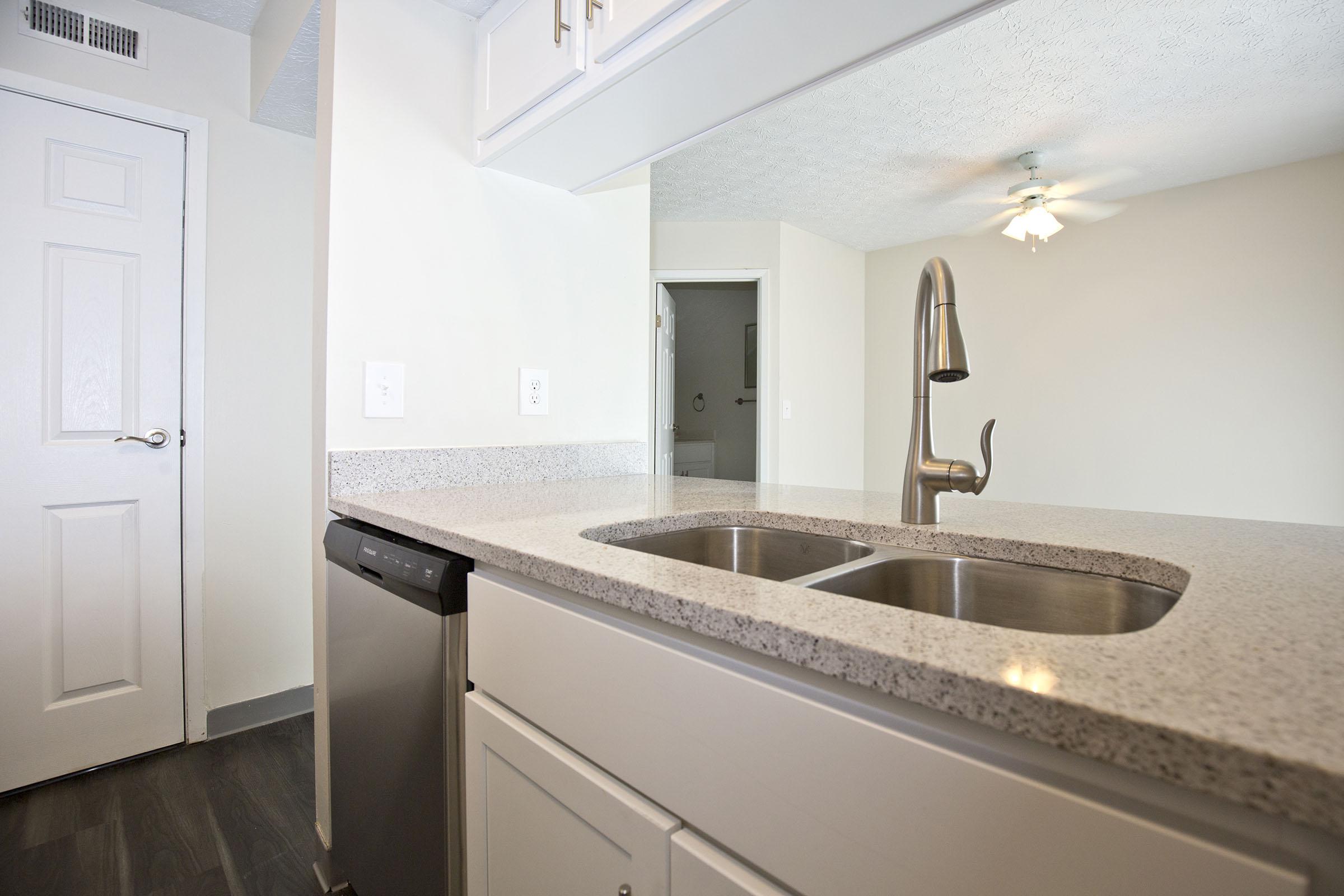 a kitchen with a sink and a mirror