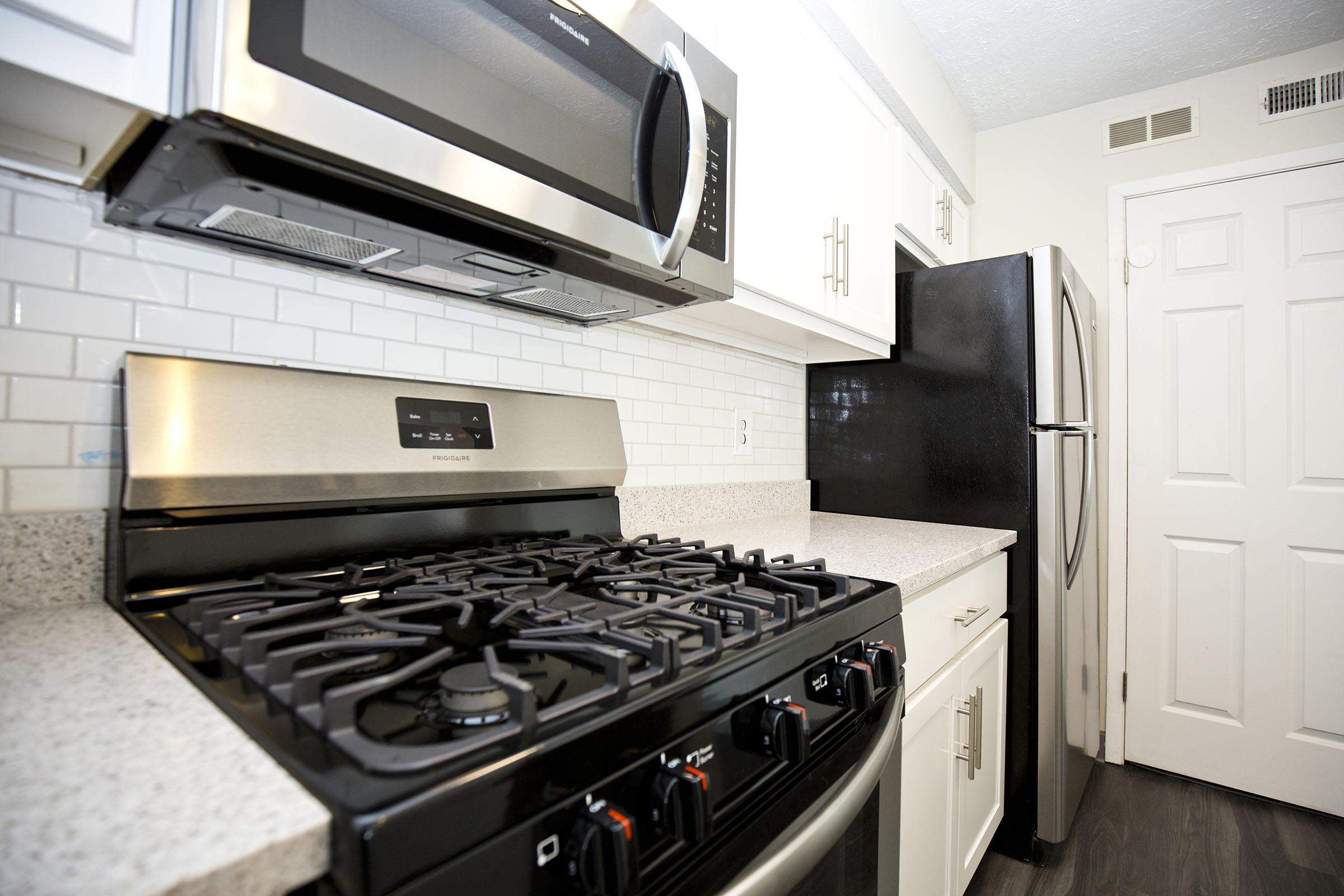 a stove top oven sitting inside of a kitchen