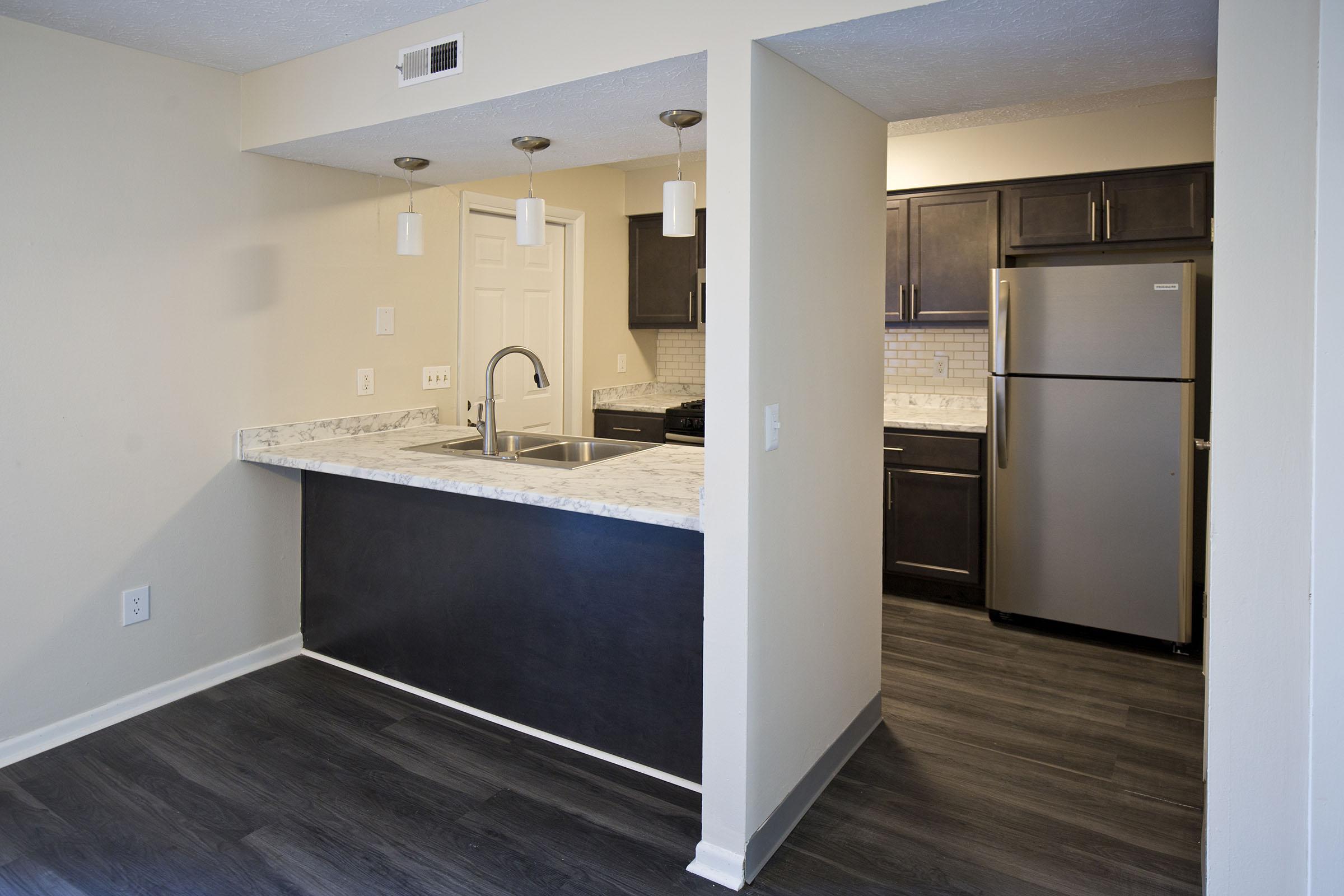 a kitchen with a sink and a mirror