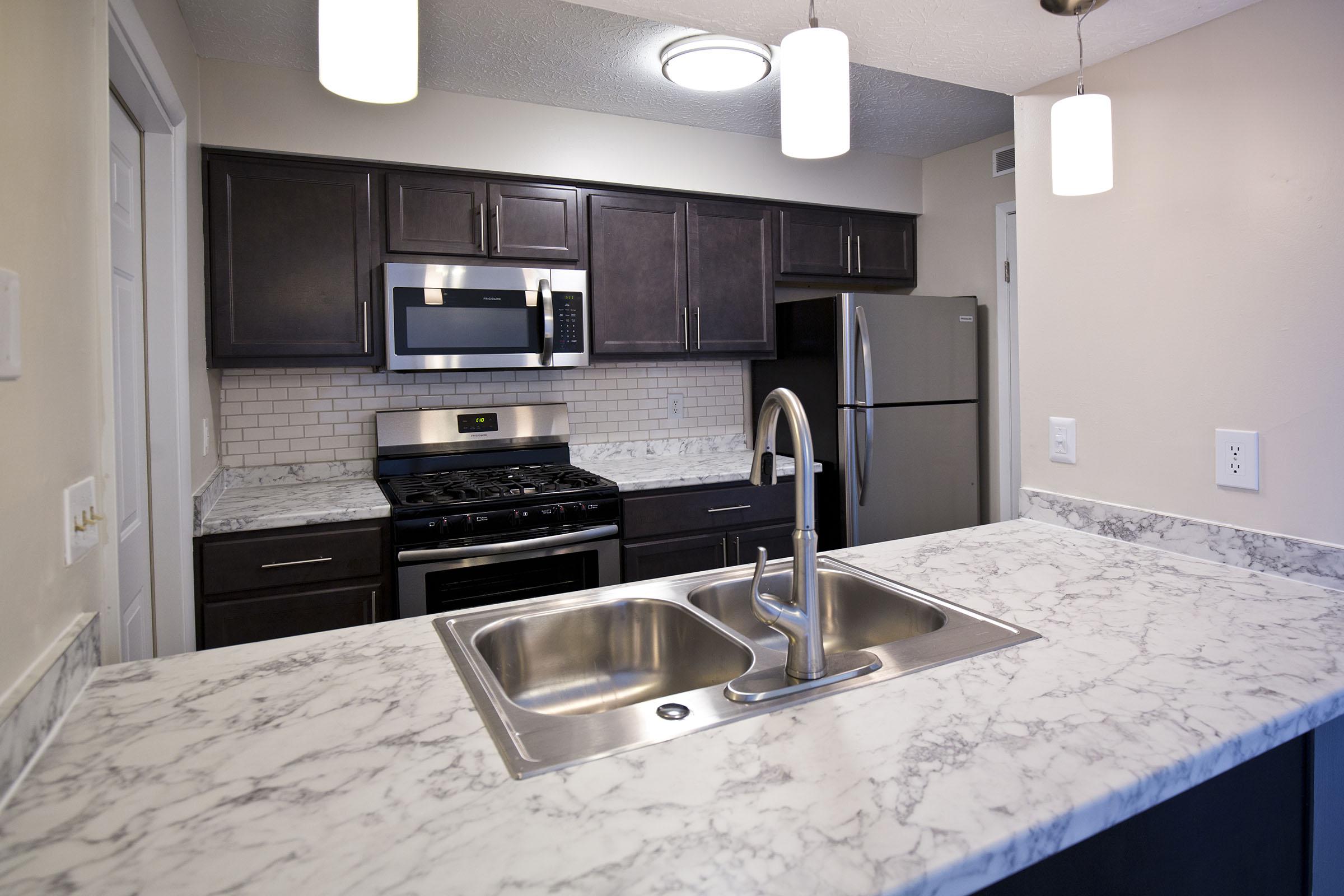 a kitchen with a stove and a sink