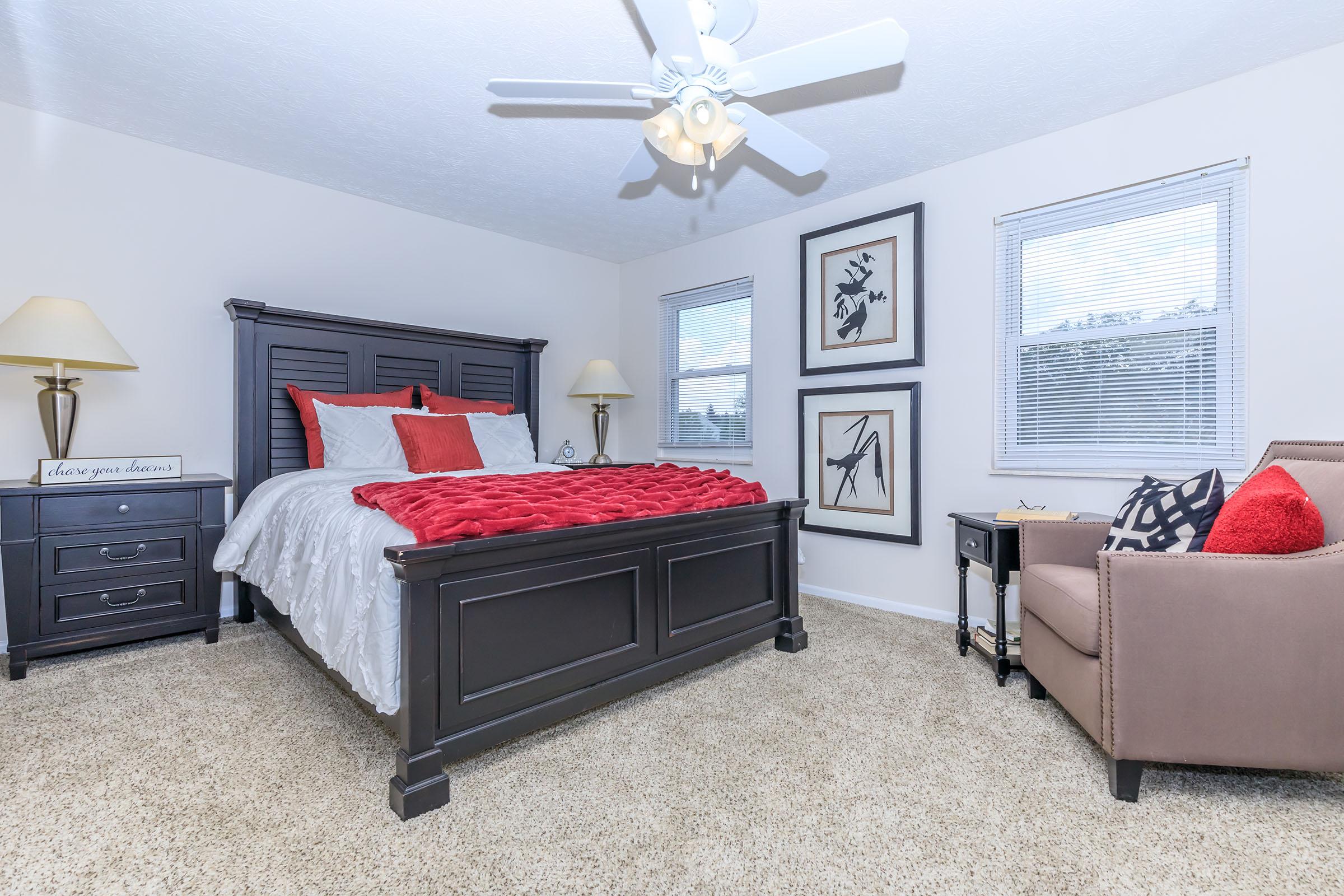 a bedroom with a bed and a couch in a living room