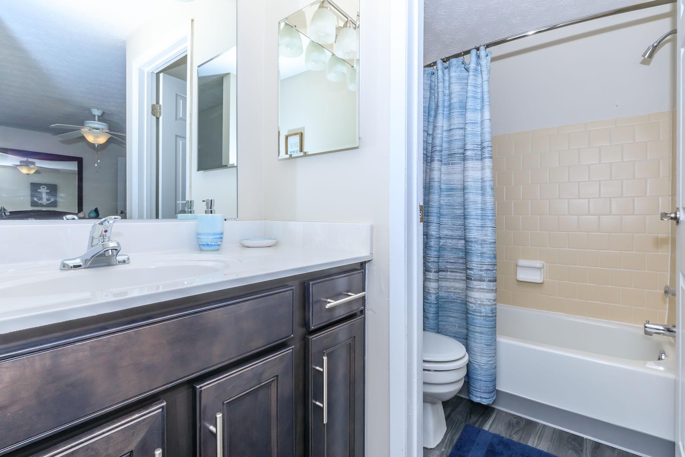 a kitchen with a sink and a mirror