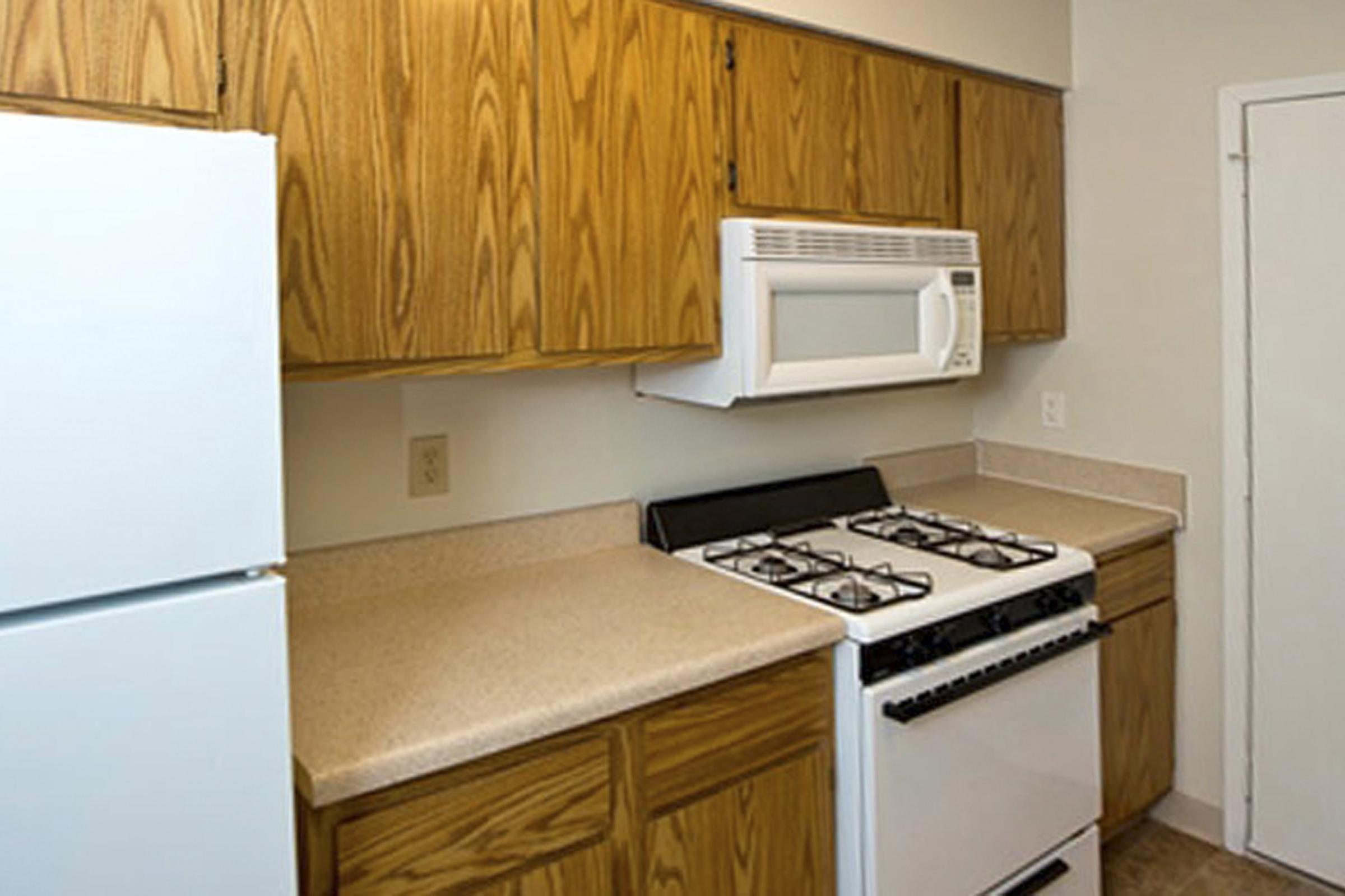 a kitchen with a stove top oven sitting inside of a refrigerator