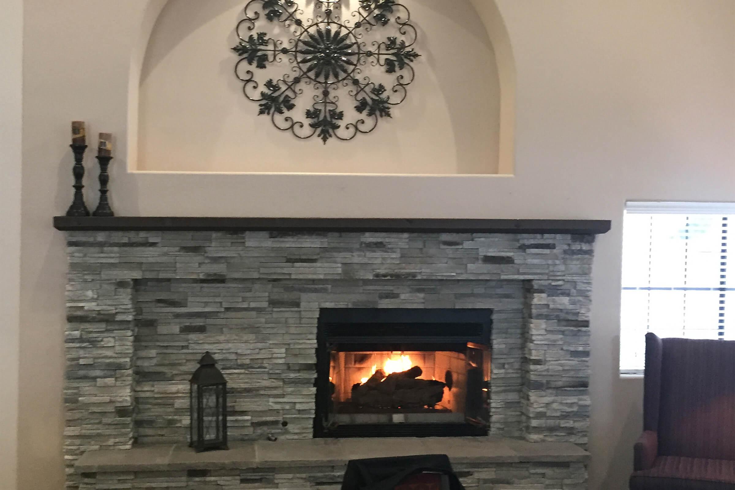 a fire place sitting in front of a fireplace