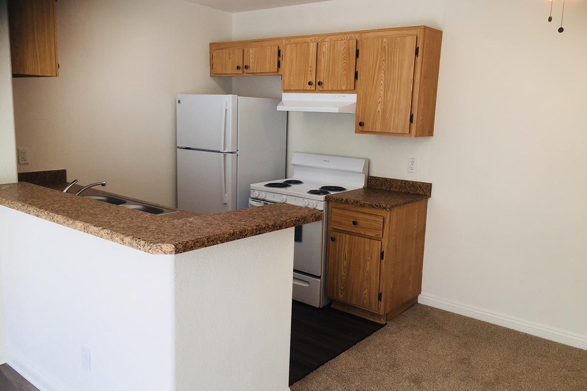 a kitchen with a sink and a refrigerator