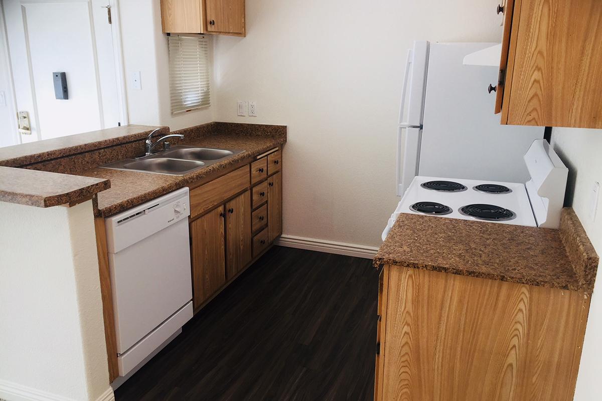 a kitchen with wooden cabinets