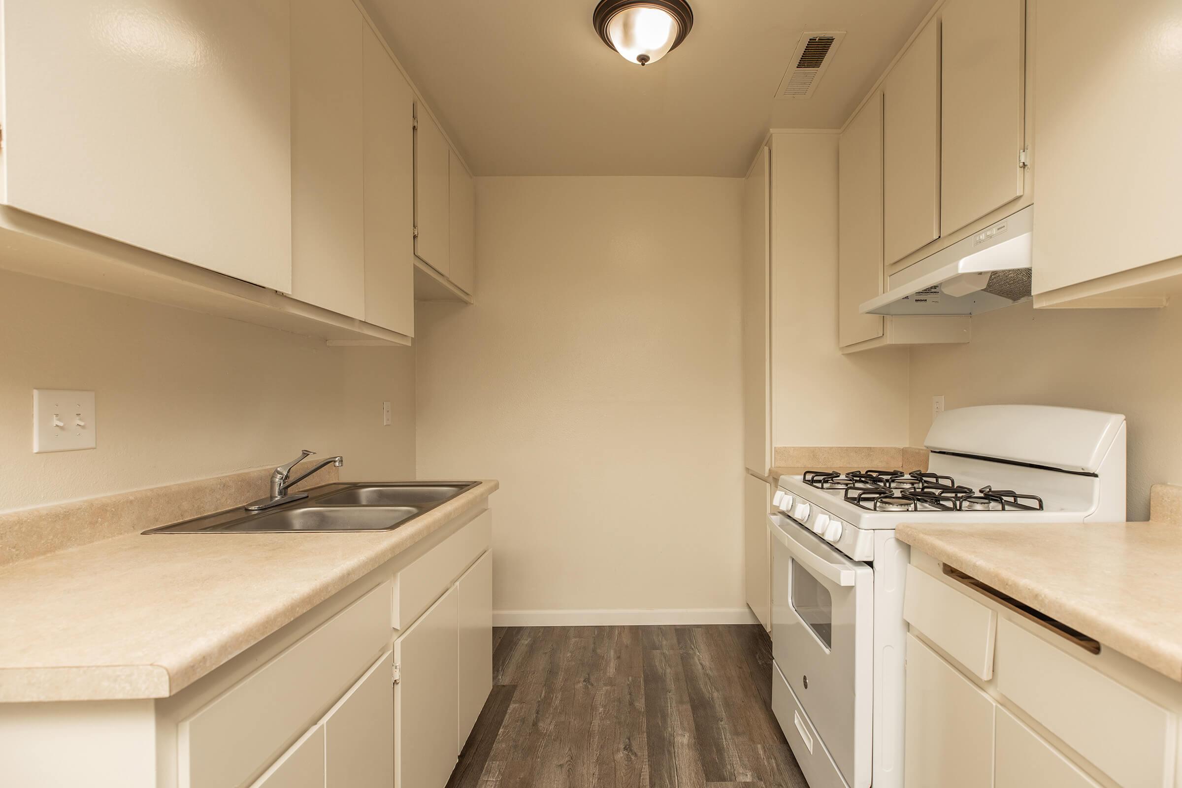 a kitchen with a sink and a mirror