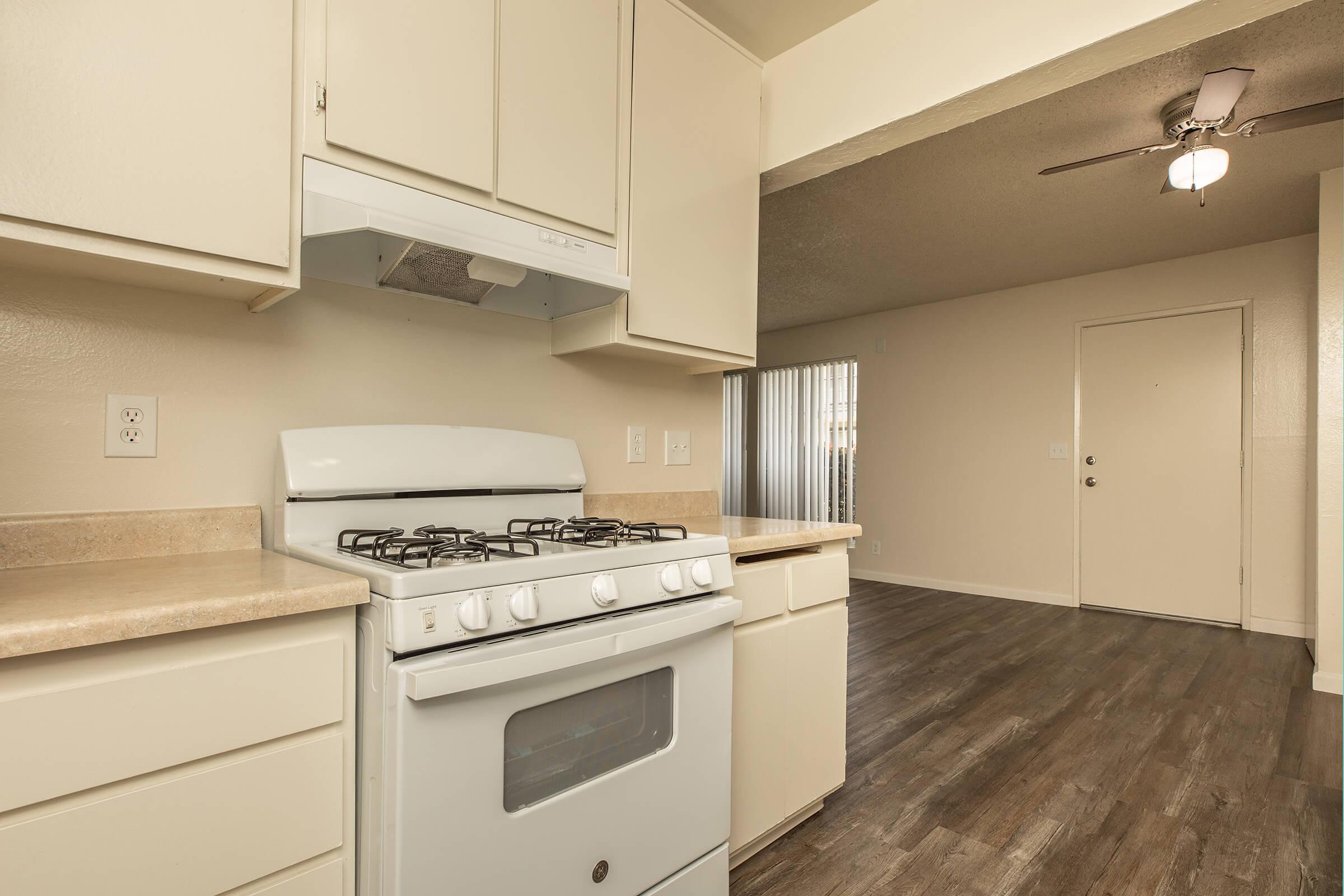 a stove top oven sitting inside of a kitchen