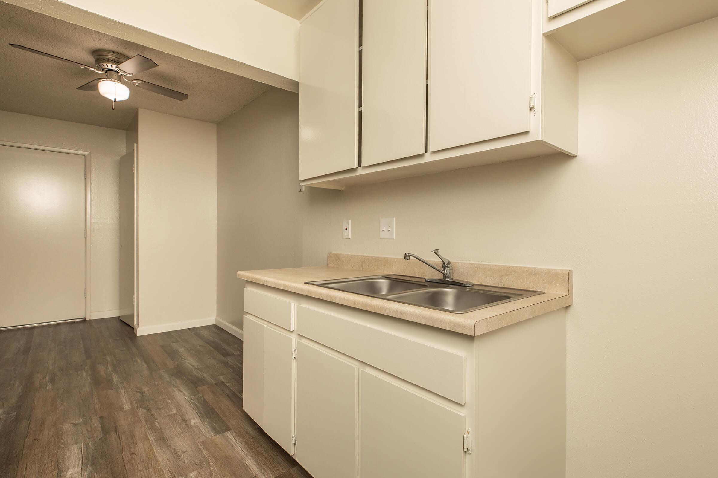 a kitchen with a sink and a mirror