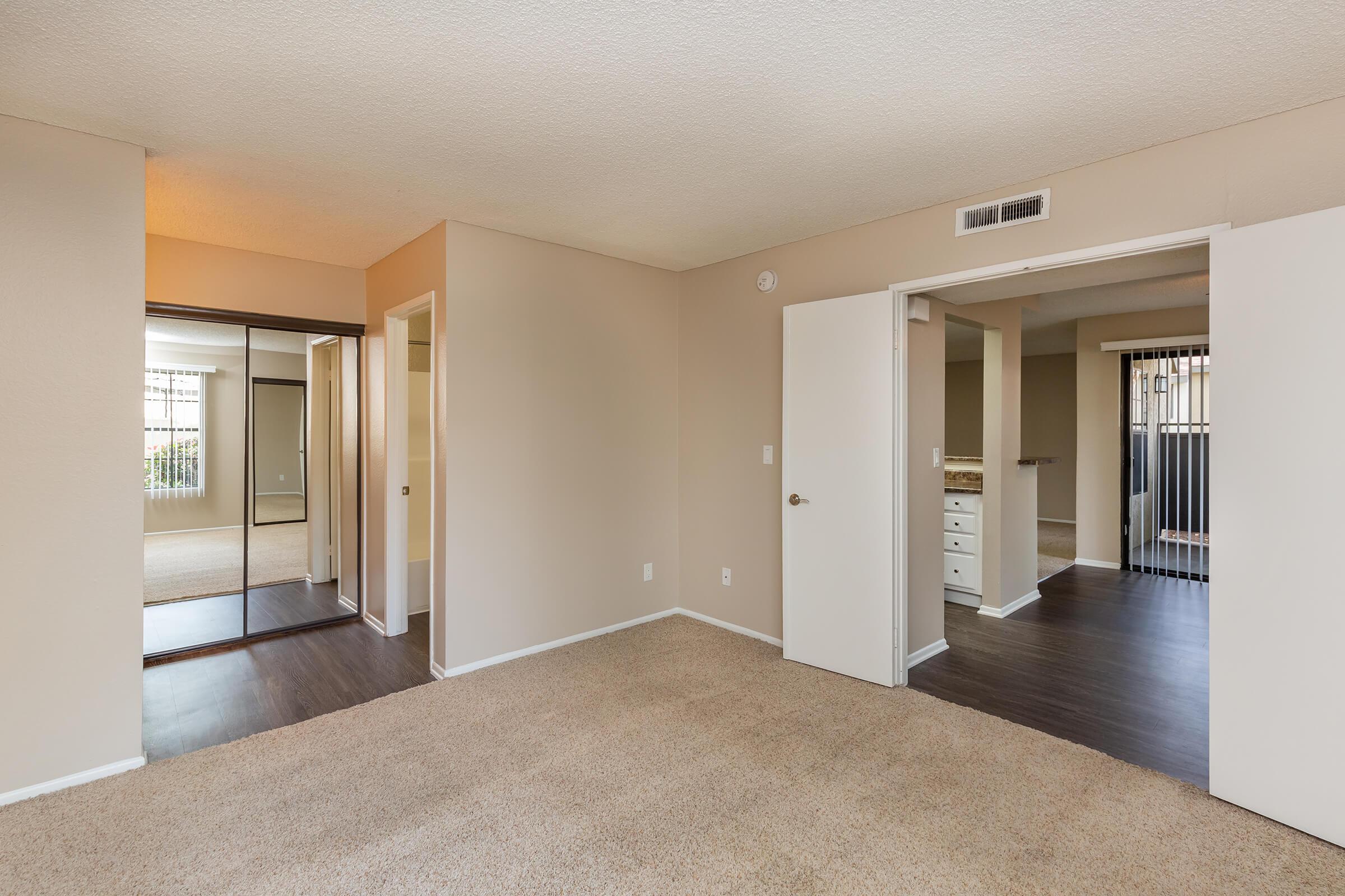 Bedroom with open bathroom door