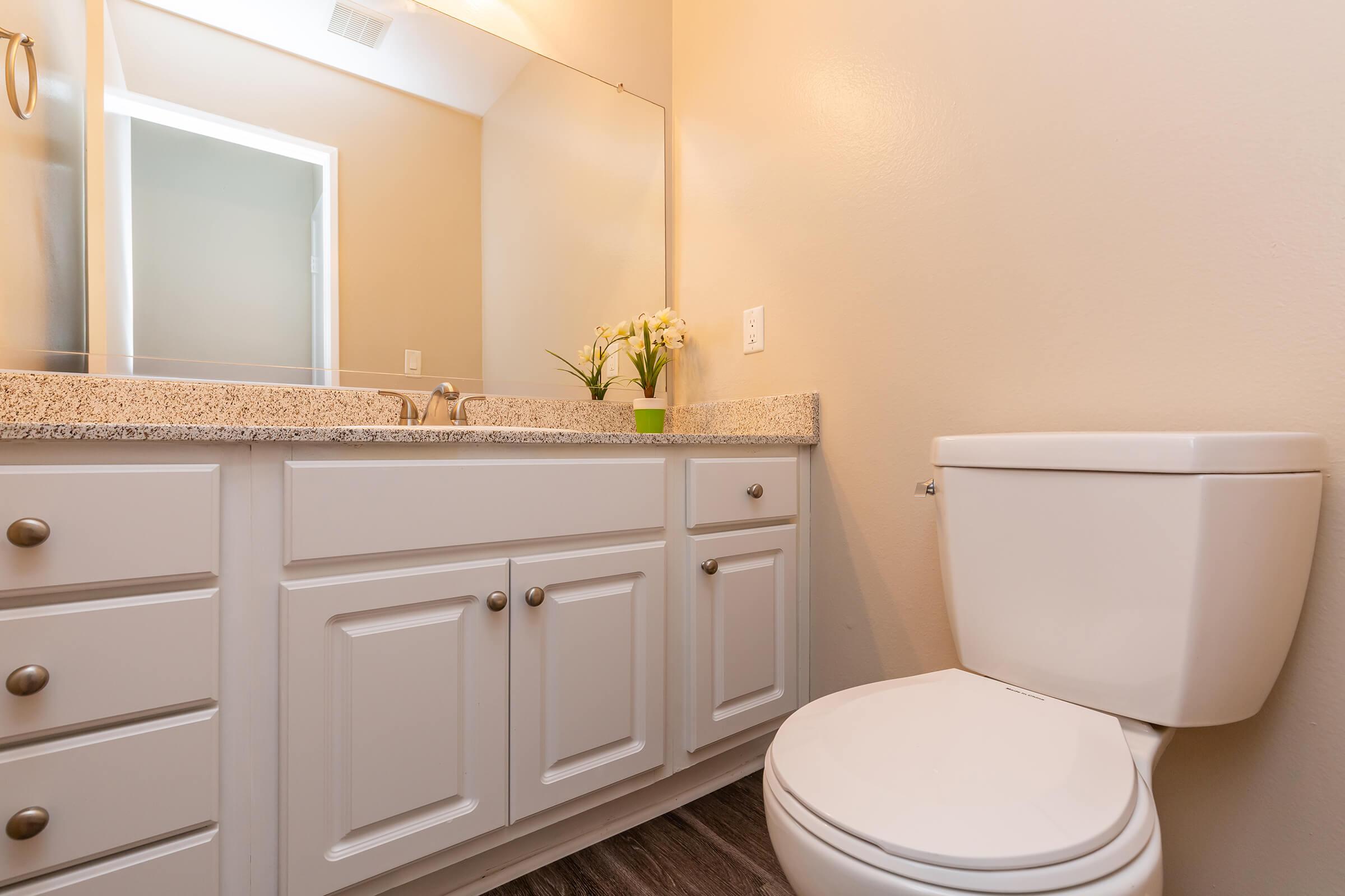 Half bathroom with white cabinets