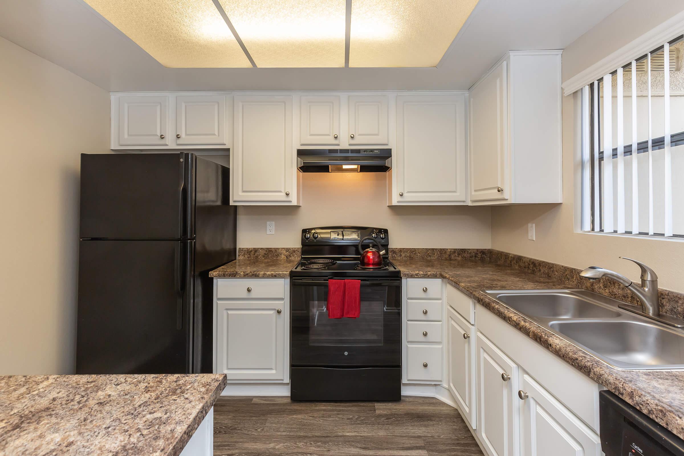 Unfurnished kitchen with black appliances