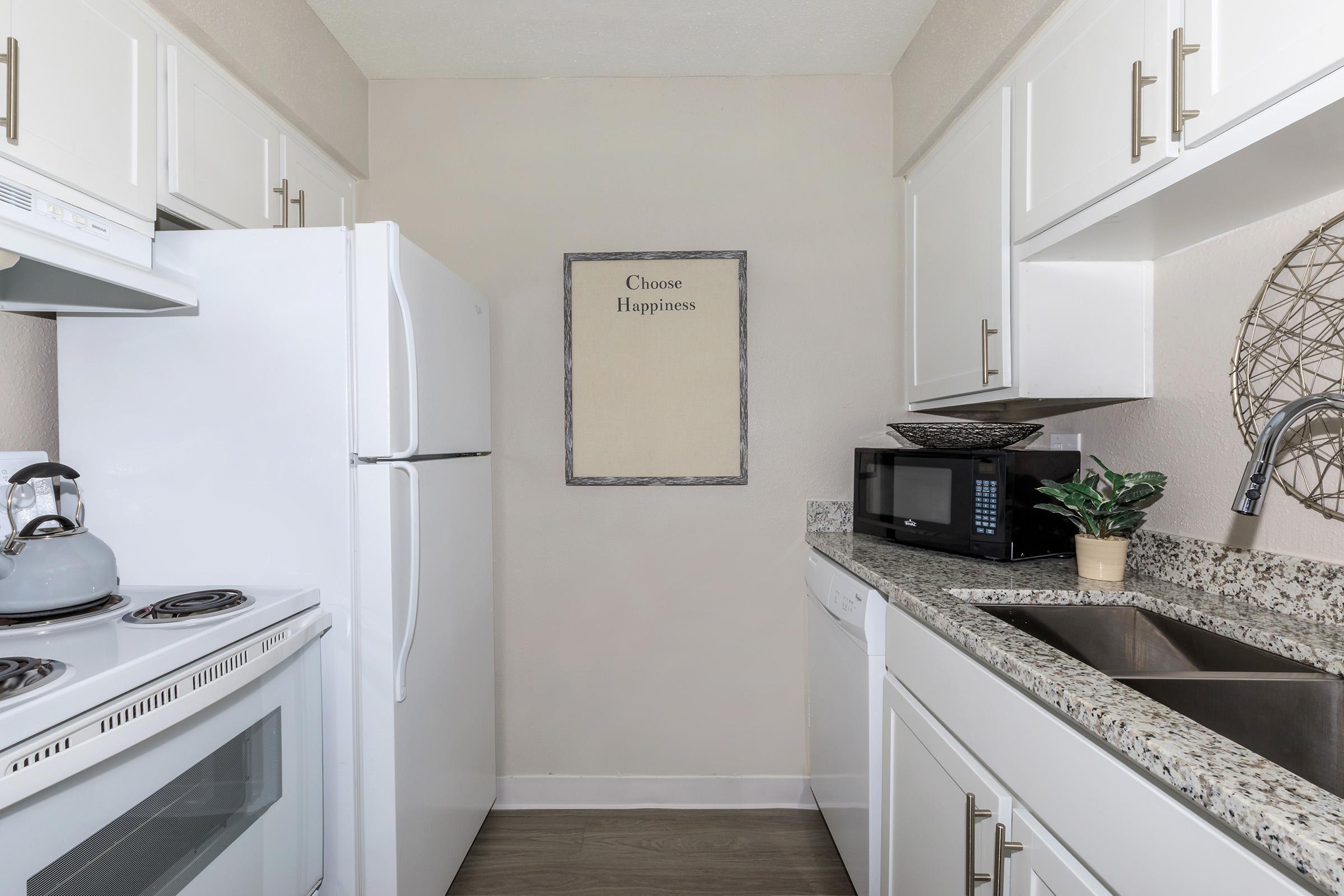 a white stove top oven sitting inside of a kitchen